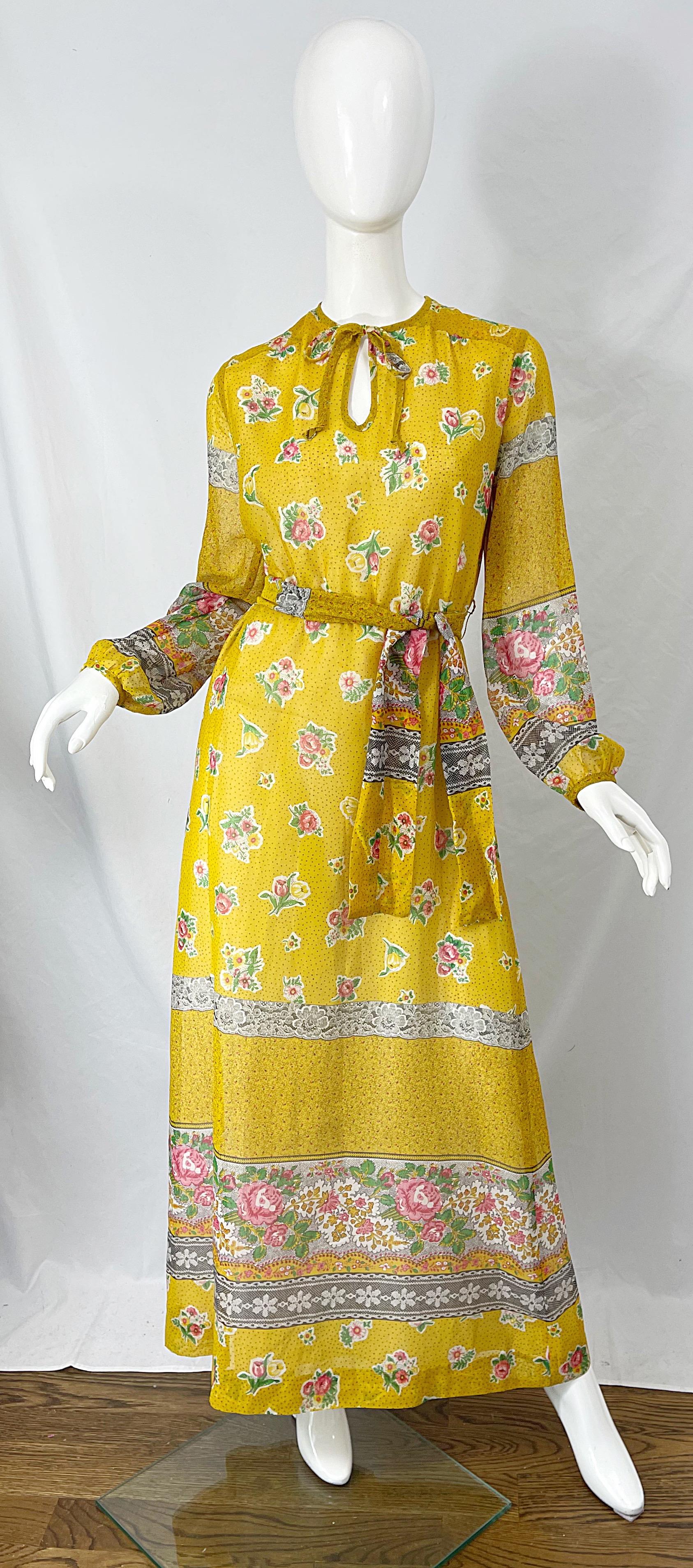 Chic early 1970s GAY GIBSON yellow cotton voile vintage trompe l’oeil lace and flower print lightweight long sleeve belted maxi dress ! Features the perfect vibrant marigold yellow color. Gray and white lace printed stripes throughout with bouquets 