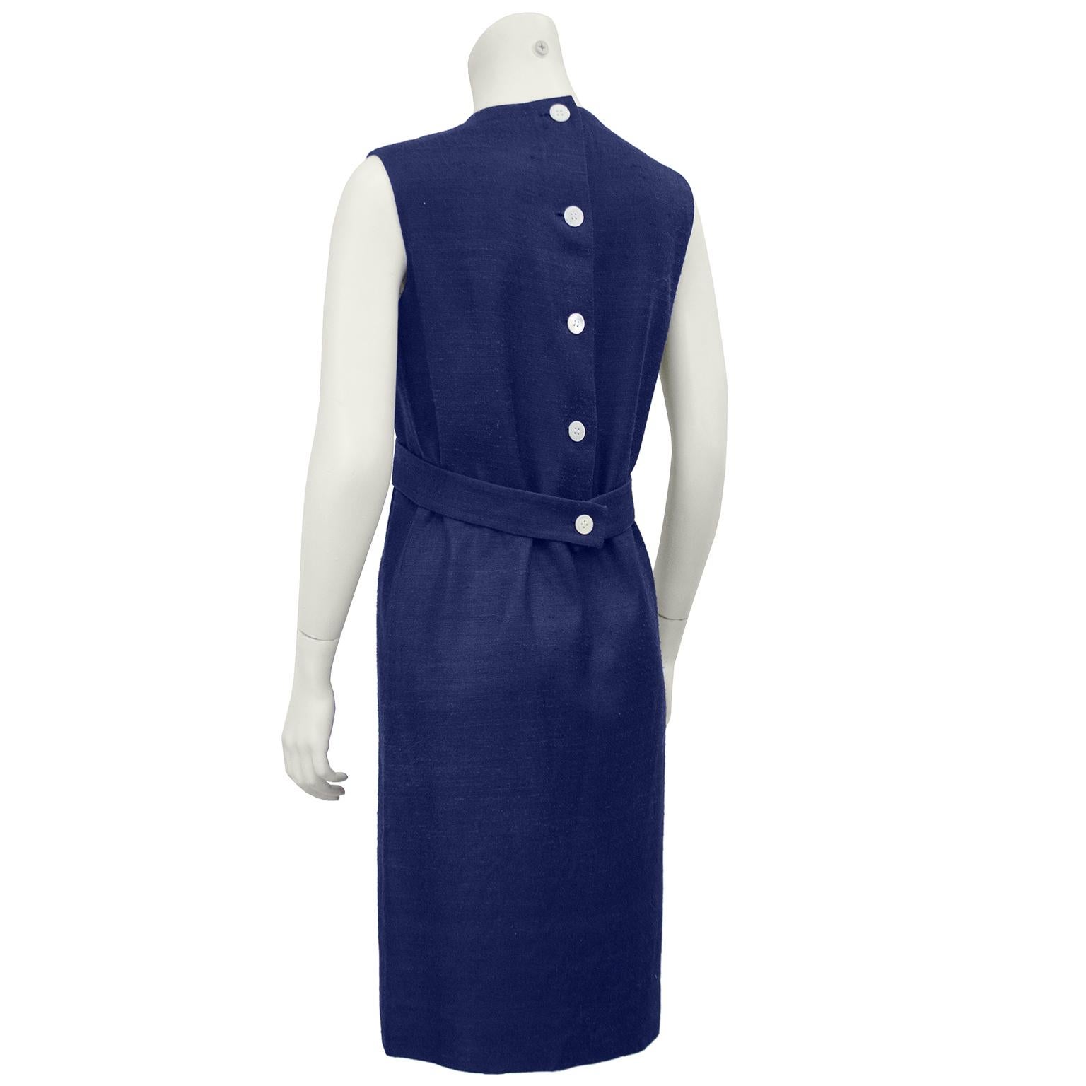 1970's Geoffrey Beene demi couture navy raw silk sleeveless dress with oversized round ivory colored buttons up the back and half belt. Custom made for a loyal client back in the 1970's, this simple, elegant dress can be worn to almost any occasion.