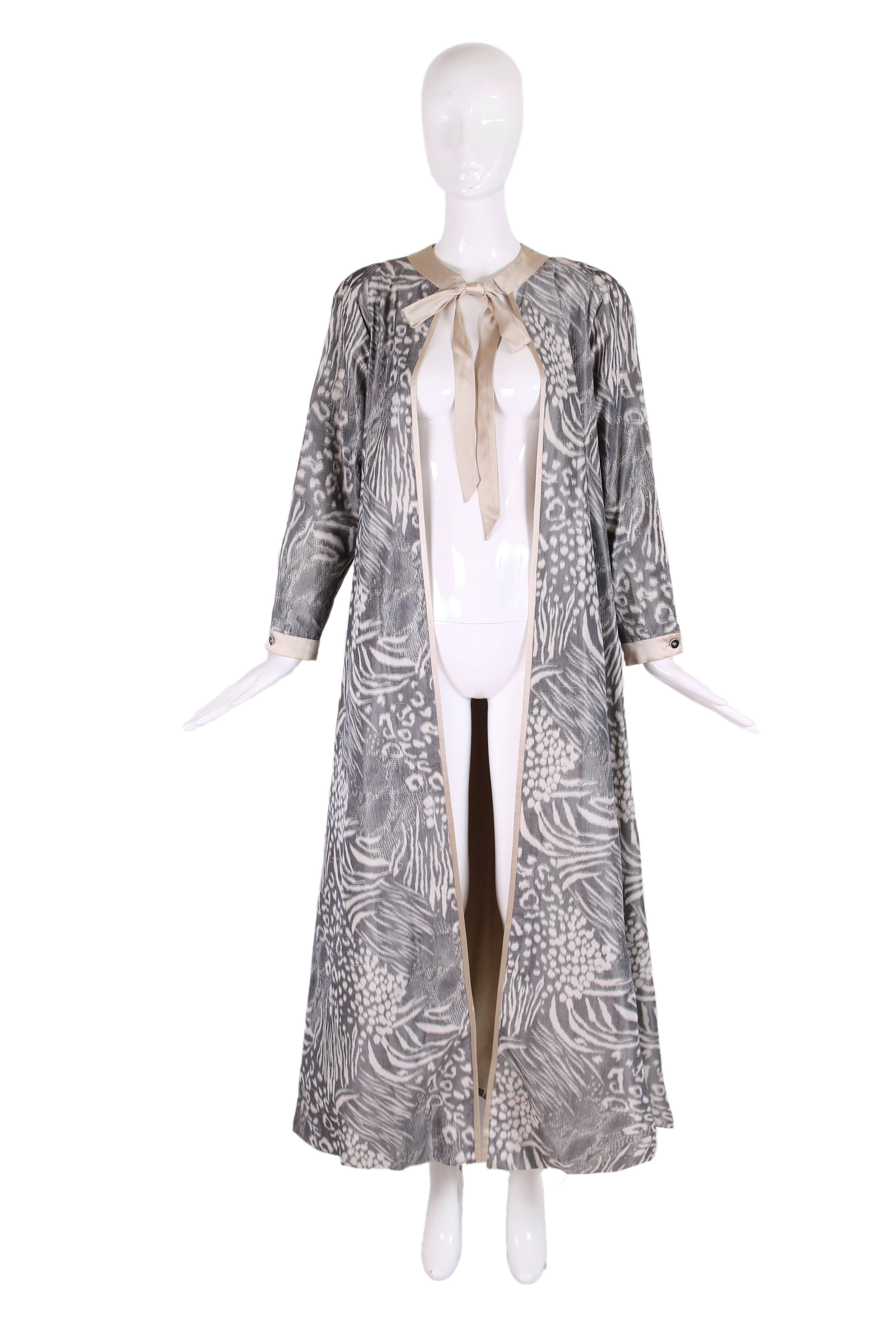 1970's Geoffrey Beene silk taffeta dress coat in grey & cream abstract geometric print with cream silk charmeuse trim, neck ties, and lining. There is a creme silk charmeuse 