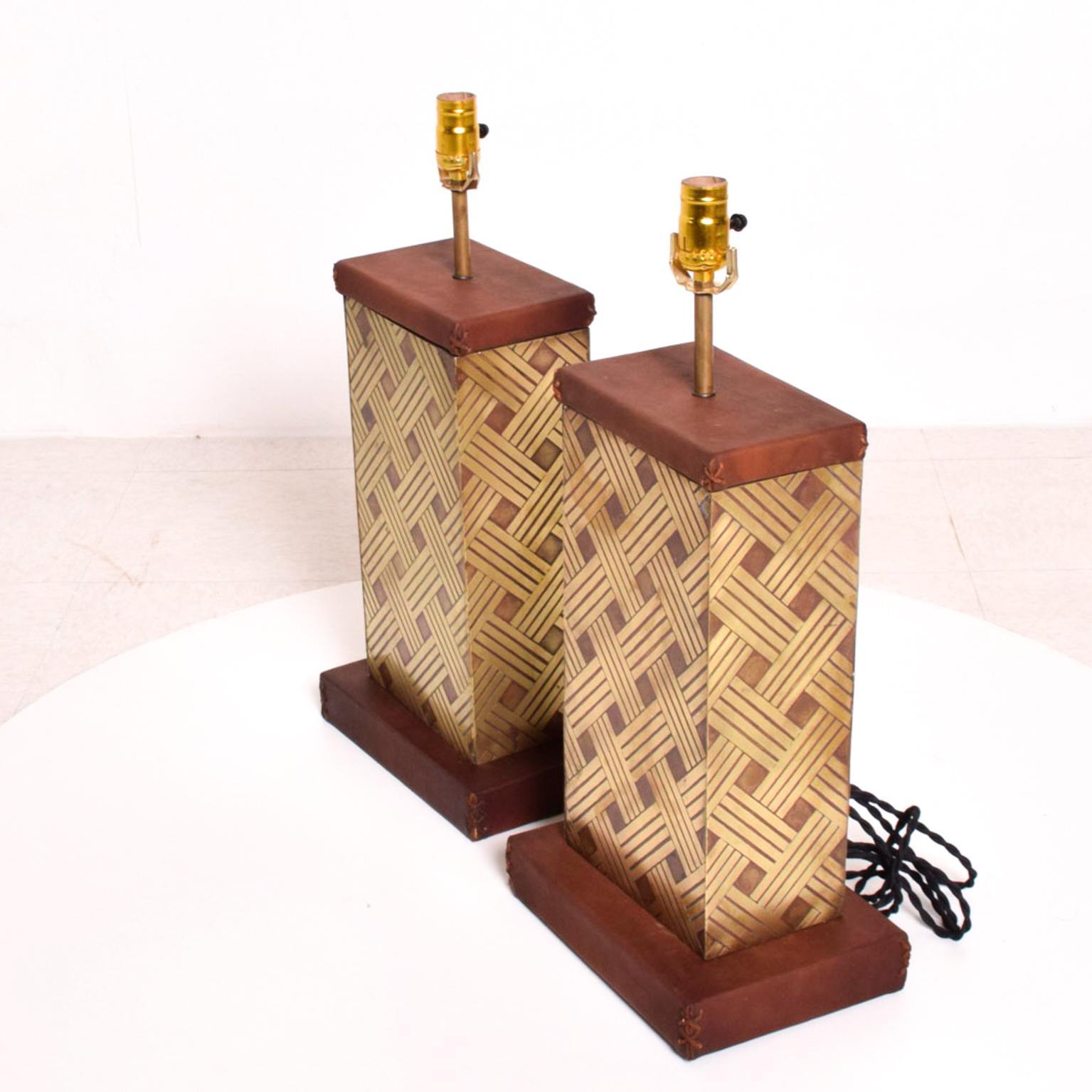 Table Lamp Pair Leather & Bronze
Pair of Midcentury Table Lamps. Geometric modernist design. 
Fabulous leather X Tie Detail.
Wood-base with saddle leather on bronze body. Bronze sheet with geometrical texture.
Made in Mexico. 1970s. Style of Luis