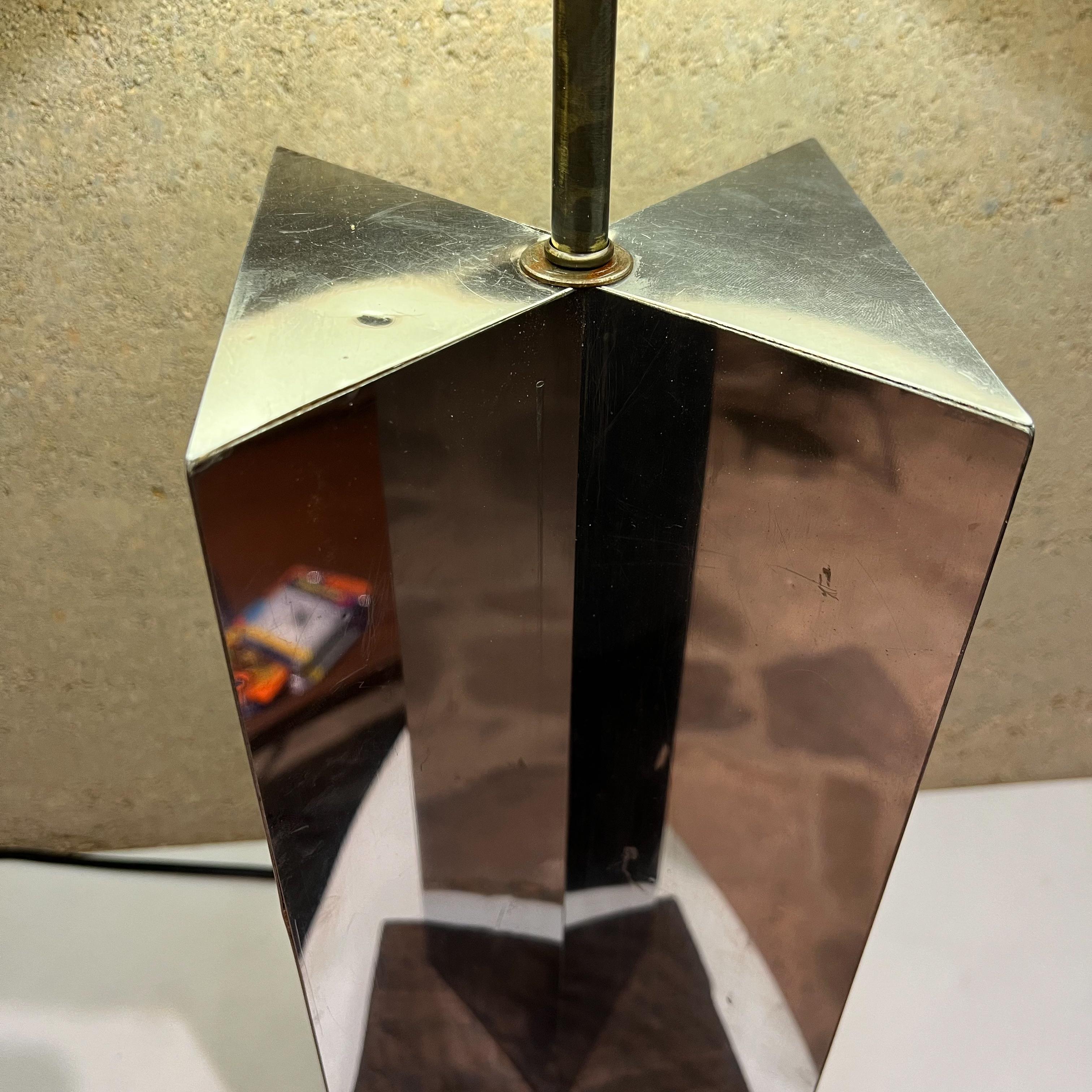 1970s Mid-Century Modern geometric citiscape modern chrome table lamp 
Style of Paul Evans
Unmarked
Chrome plated stainless steel mounted on exotic wood.
MJeasures: 25.5 tall x 8 wide x 8
Preowned original unrestored vintage condition. No lamp