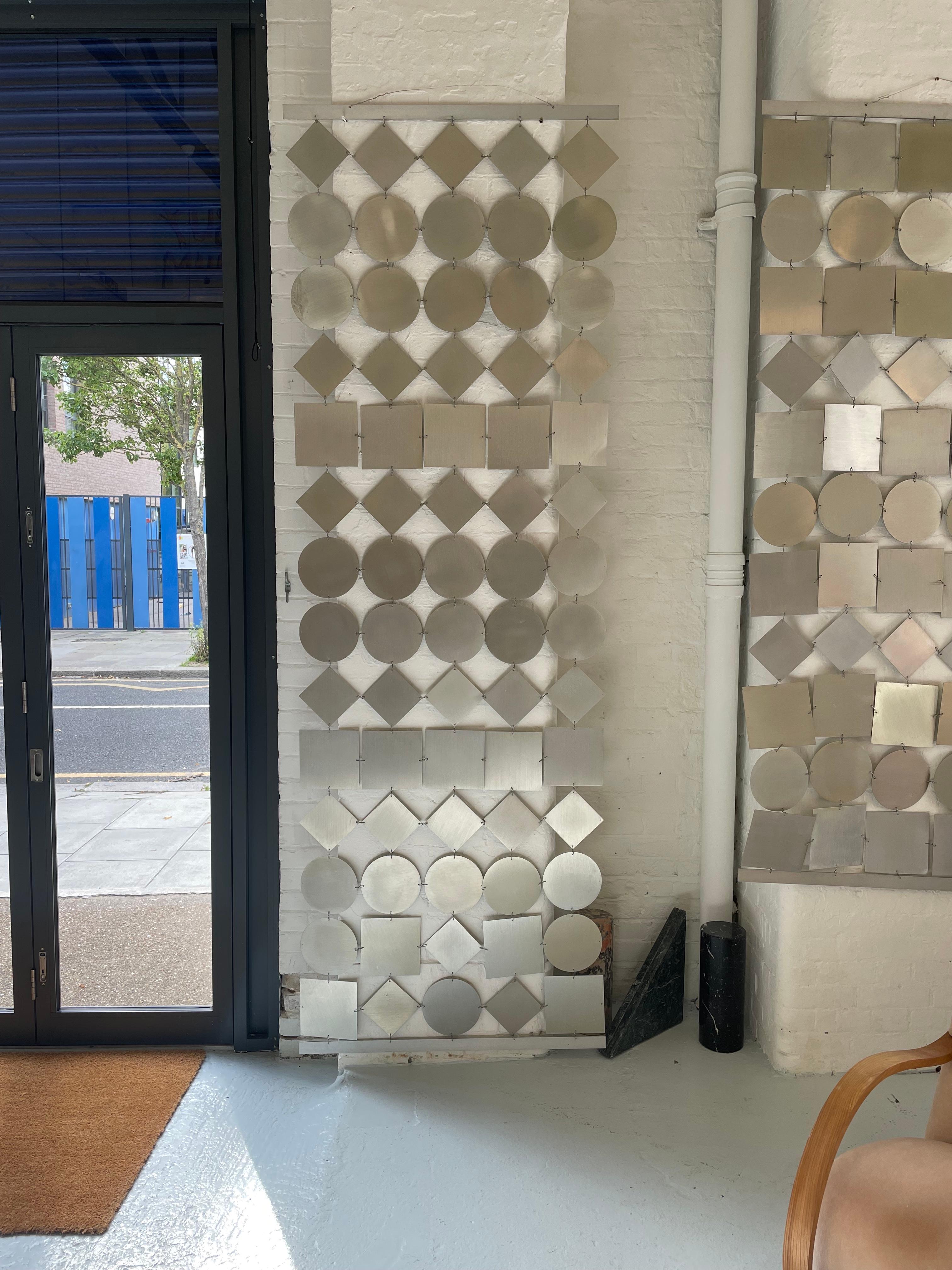 The Geometric Screen/Room Divider is a versatile and stylish piece that adds functionality and aesthetic appeal to any interior space. This screen features a geometric pattern, incorporating clean lines and bold shapes. It is crafted from metal.