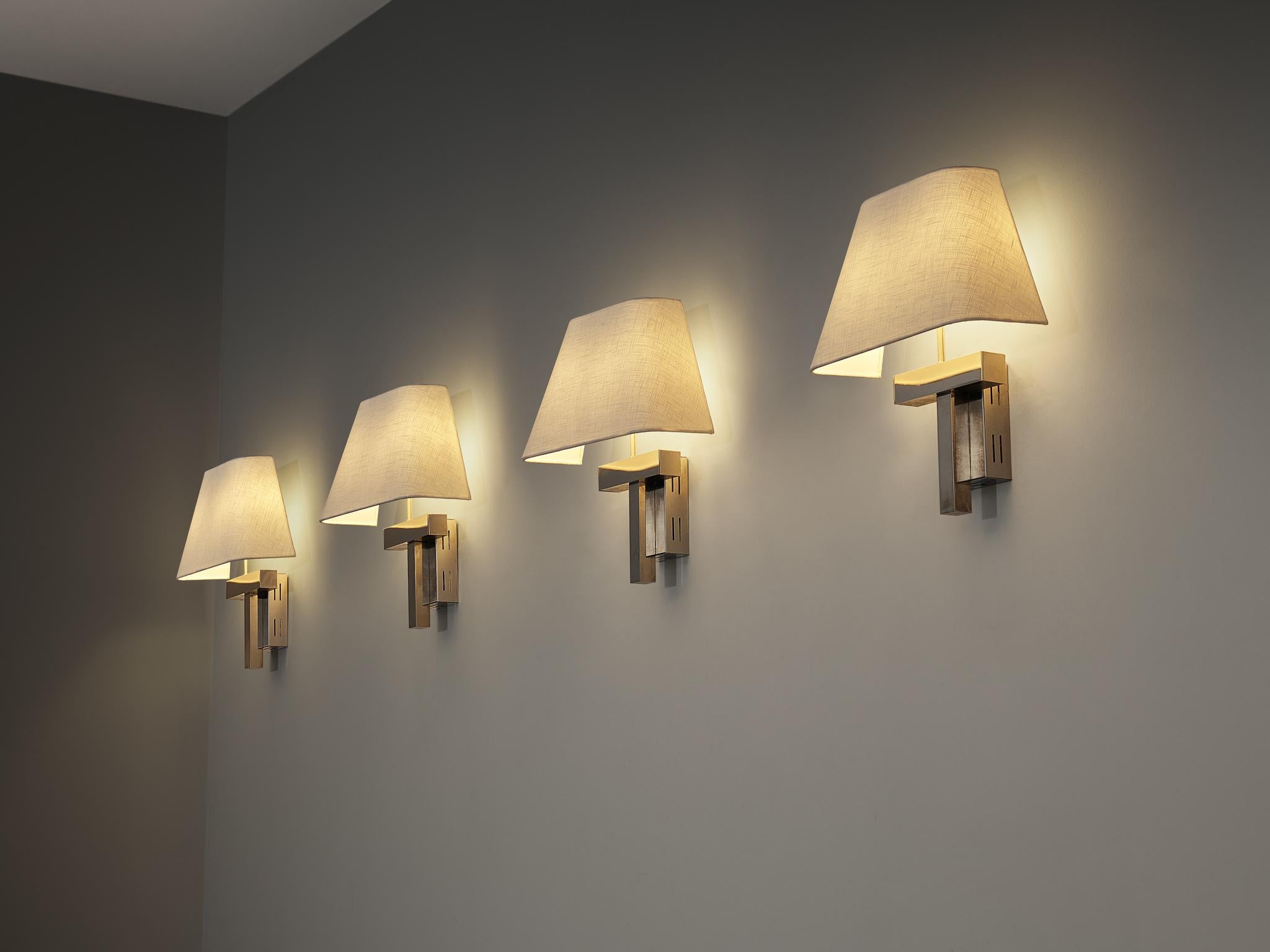 Wall lights, chrome-plated metal, fabric, Europe, 1970s

These wall-mounted light shades feature a refined, understated design that brings a soft elegance to any interior. A striking detail lies in the cubist-inspired frame, defined by sharp lines