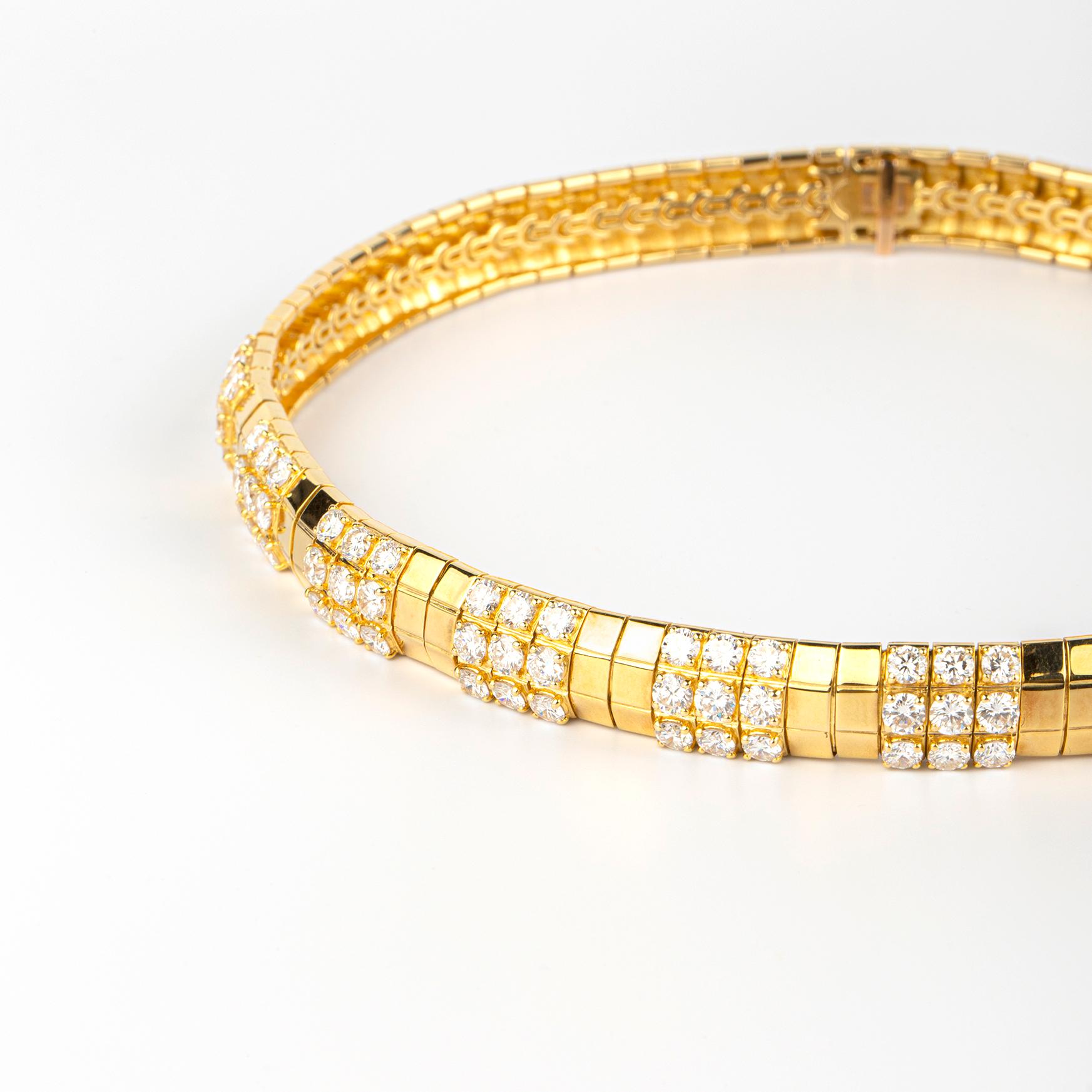 An exquisite 18k yellow gold necklace showcasing 99 round brilliant diamonds for 24 carats in total, set in a geometric design. Made in France, circa 1970.
