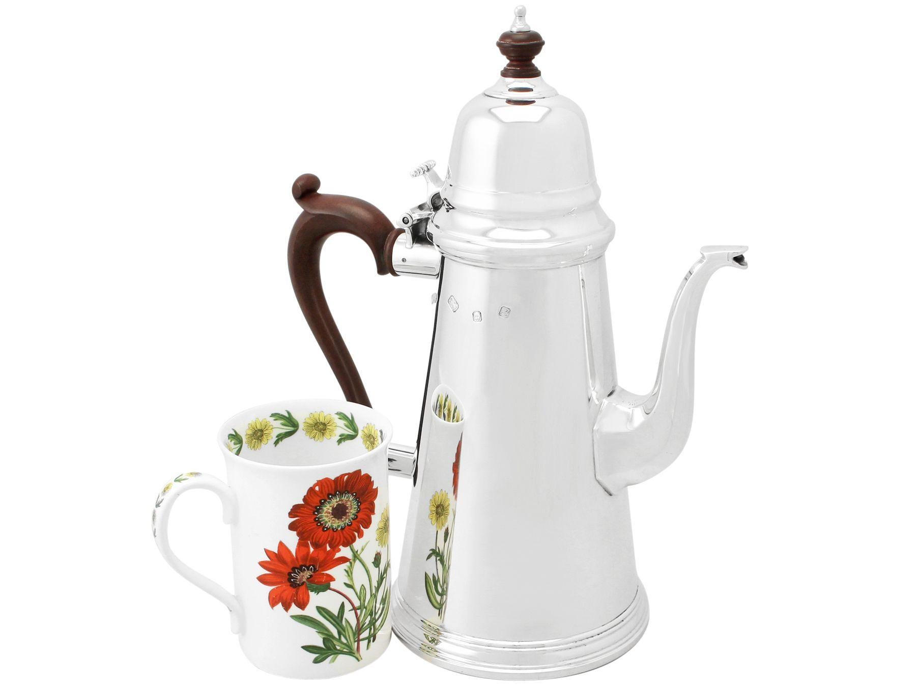 A fine and impressive vintage Elizabeth II English sterling silver coffee pot crafted by Reid & Sons Ltd, in the George I style; an addition to our collectable teaware collection

This fine vintage Elizabeth II sterling silver coffee pot has a