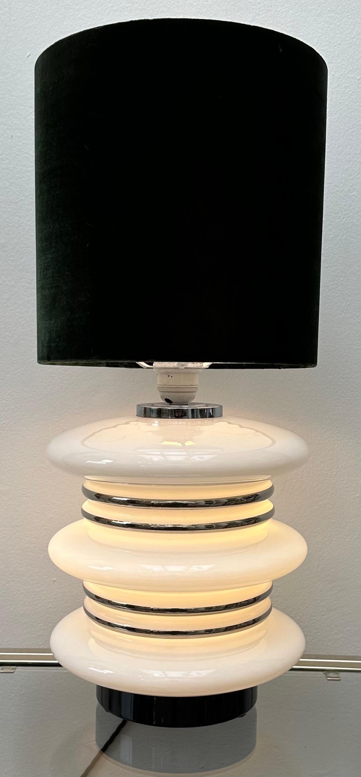 1970s German, futuristic, space-age, white opal glass and chrome table lamp attributed to Leclaire & Schäfer. The illuminated lamp base requires two E27 screw-in lightbulbs inside with each one pointing in opposite directions which allows the light