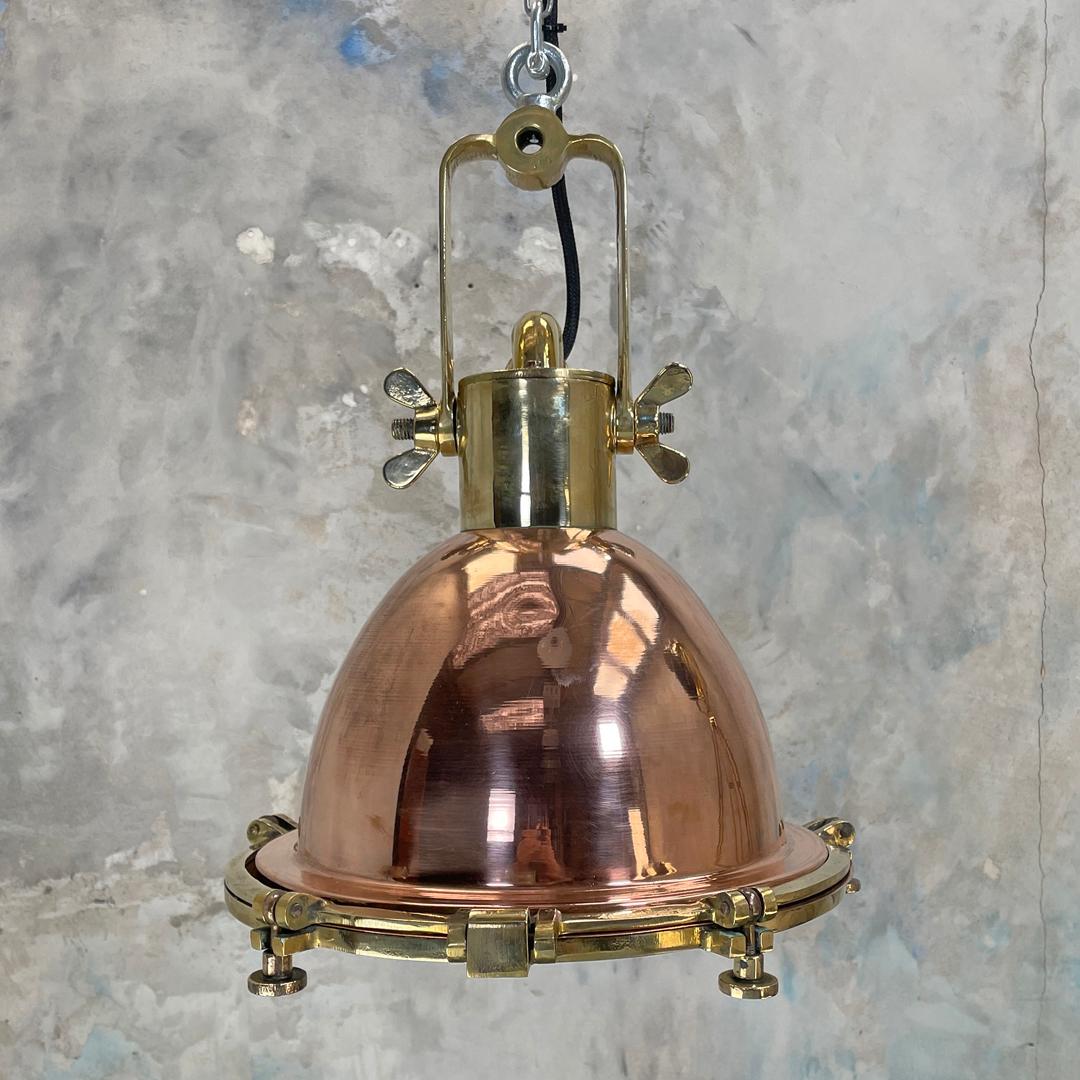 A copper and brass industrial style ceiling light. This original industrial light fixture is manufactured by Wiska who are a German manufacturer of marine grade fixtures and fittings.

Beautiful copper feature lighting for vaulted ceilings,