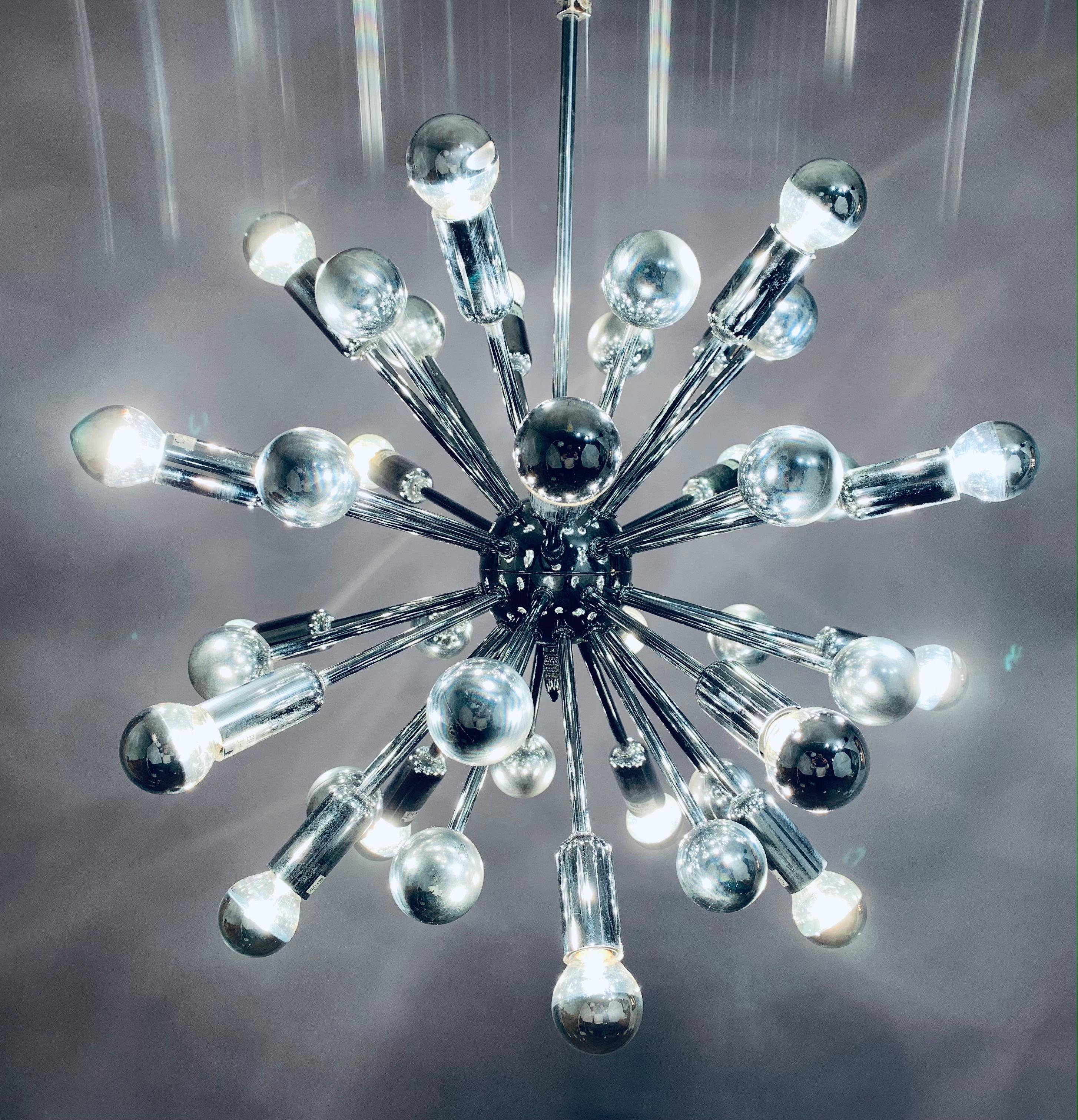 An absolutely stunning chromed-metal sputnik pendant hanging light attributed to Cosack Leuchten. No manufacturers label is present but the bulb holders are the same on others I have researched. Designed in Germany by Cosack during the 1970s. 20
