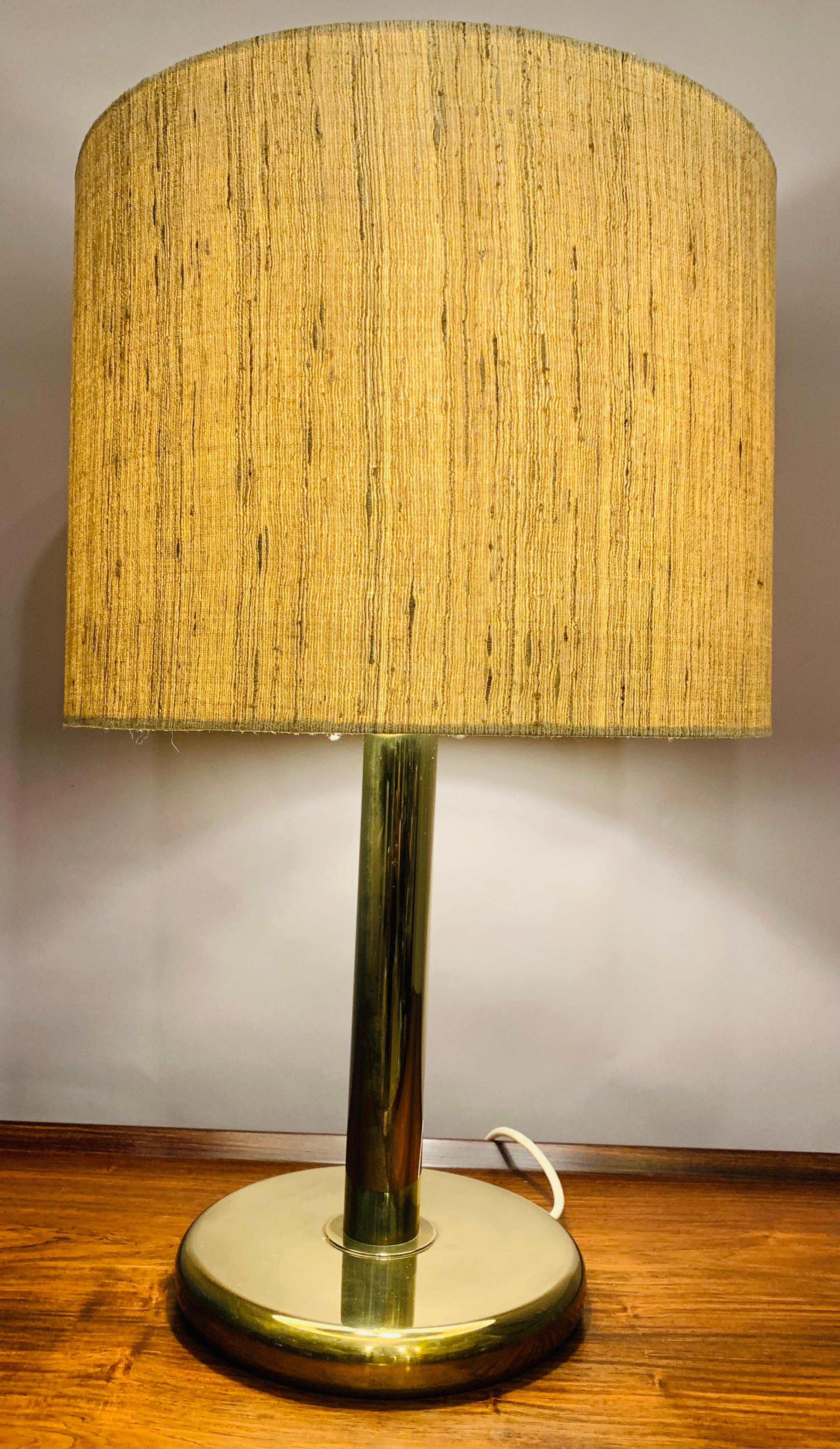 1970s German Cosack Leuchten circular brass table lamp which includes the original shade. The table lamp is heavy and very well made. The on/off switch sits along the white flex. Two E27/E26 screw in bulbs are required. The shade is held in place