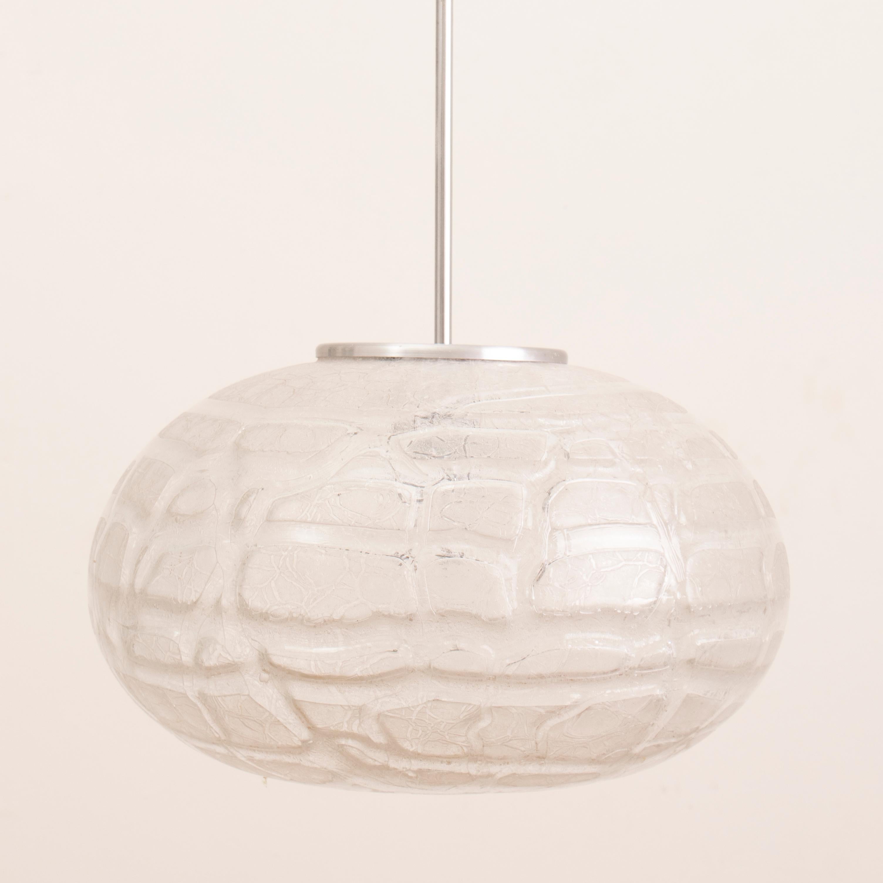 1970s crackle, frosted, glass, pendant, hanging-light in the shape of a pumpkin manufactured by Doria Leuchten, Germany. The glass globe is suspended from a polished chrome fixture and black wire flex which can be adjusted to your specific height