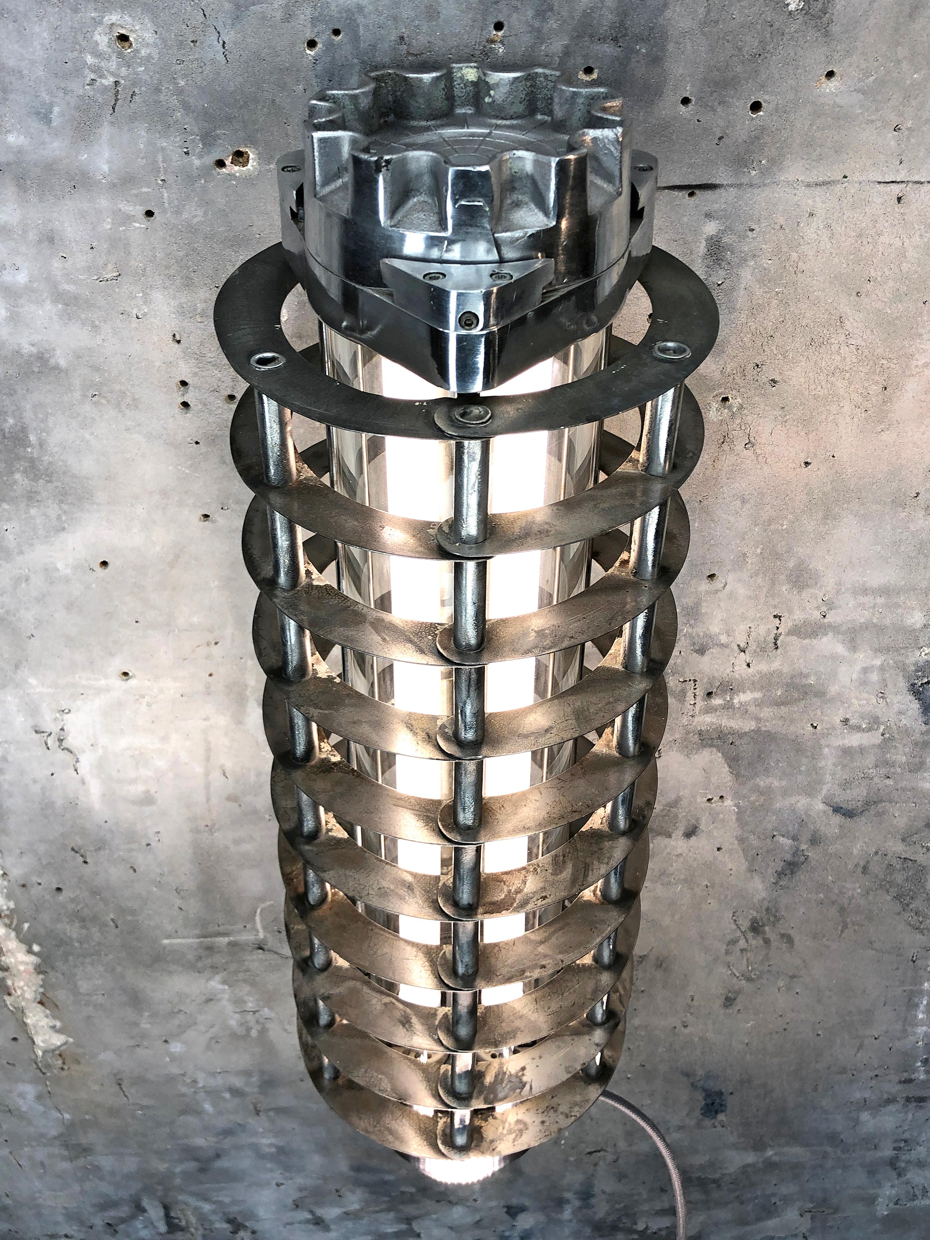 A retro Industrial aluminum wall-mounted flameproof striplight with protective cage by Wittenberg. Reclaimed from supertankers and military vessels then professionally stripped, restored and rewired by Loomlight in the UK.

This fixture is