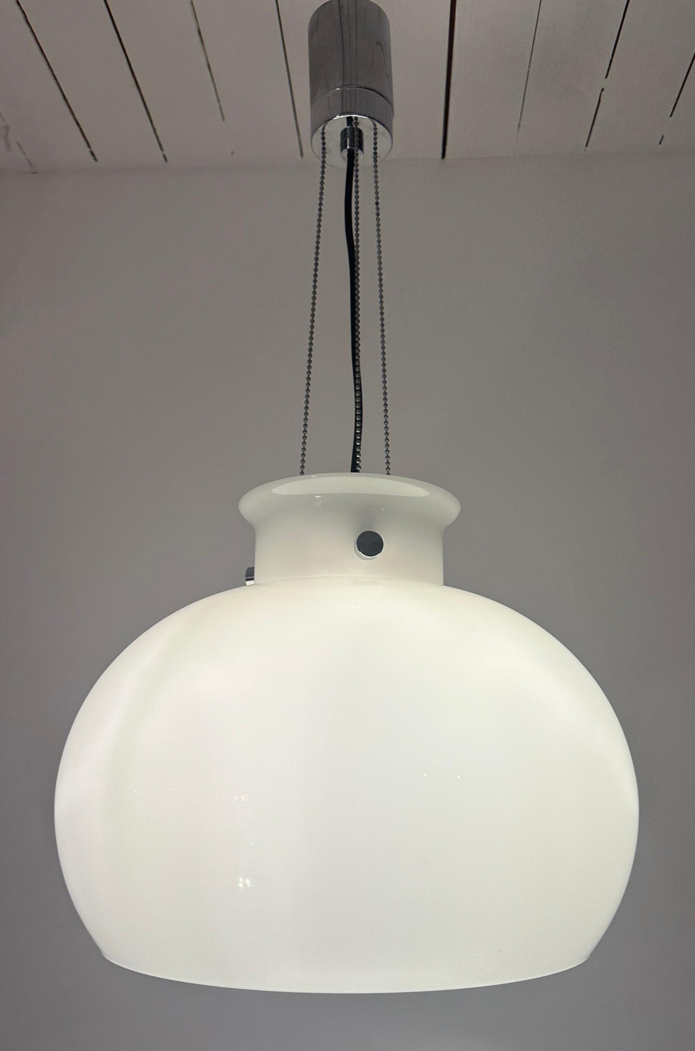  1970s German Glashütte Limburg opaline white glass pendant hanging ceiling light.  The bell-shaped shade is fixed to a polished chrome frame which is suspended horizontally in place by three chrome chains to a chrome circular bracket.  The height