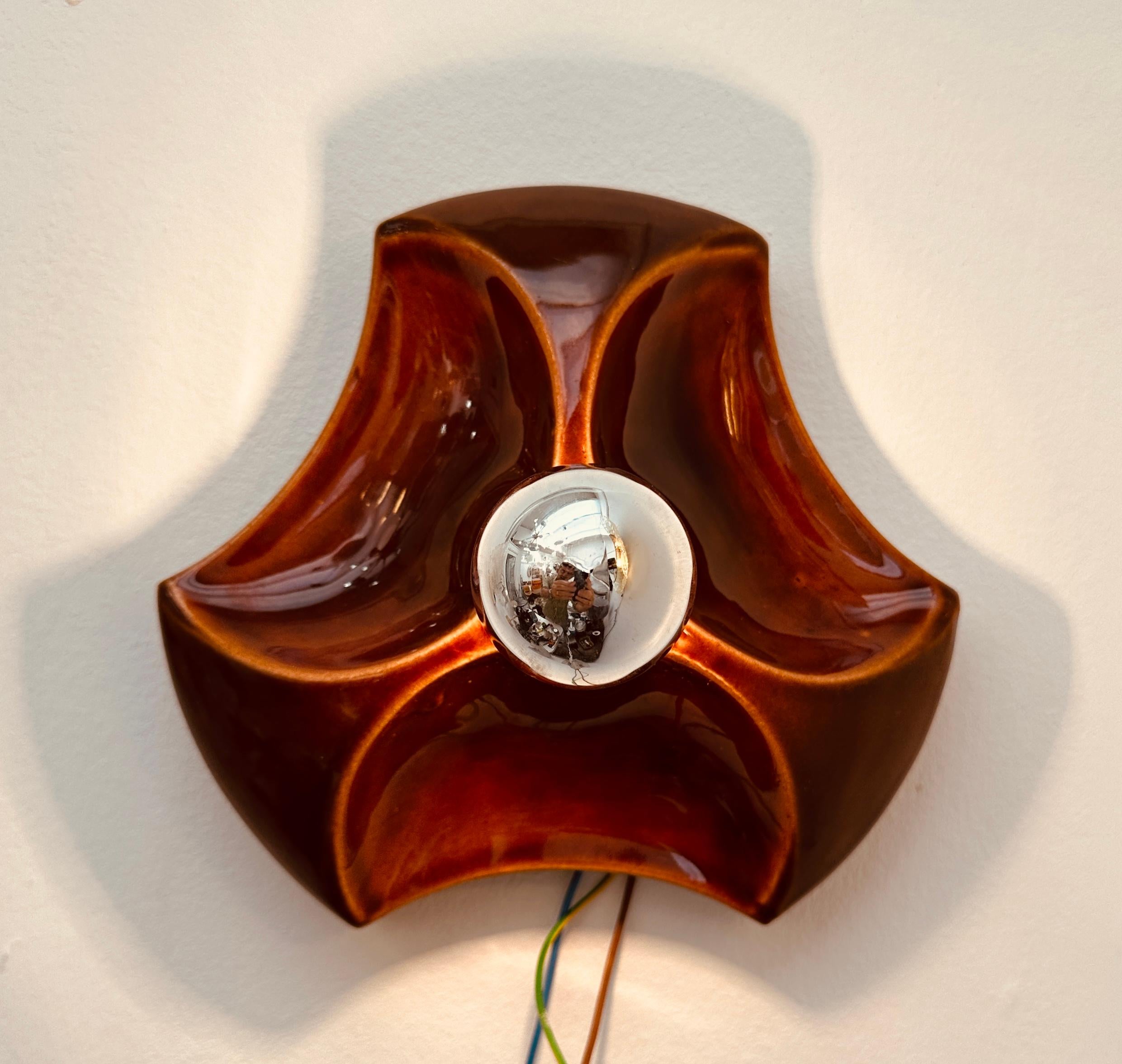 1970s vintage, retro, space-age, German Hustadt Leuchten 'Fat Lava' ceramic brown glazed glossy wall sconce with a 3-dimensional design.  A single E14 screw in bulb sits in the centre of the triangular indented wall light.  I would recommend a