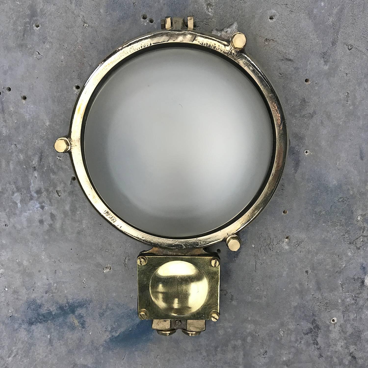 Reclaimed from cargo ships built during the 1970's these are substantial examples of bulkhead lighting with a soft / diffused light output which illuminate an area without casting shadows.

The main body of the light is cast brass with a frosted