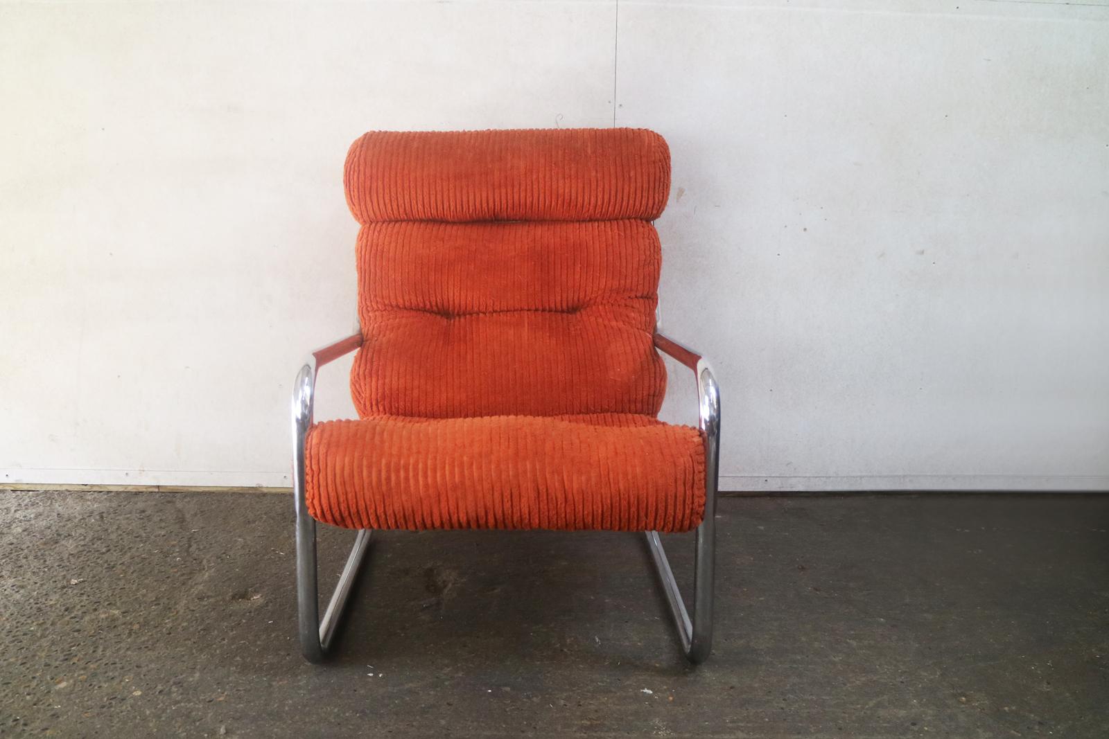 Upholstered in the original bright orange corduroy material, this is a real midcentury statement piece for any room. Tubular chrome-plated metal frame.