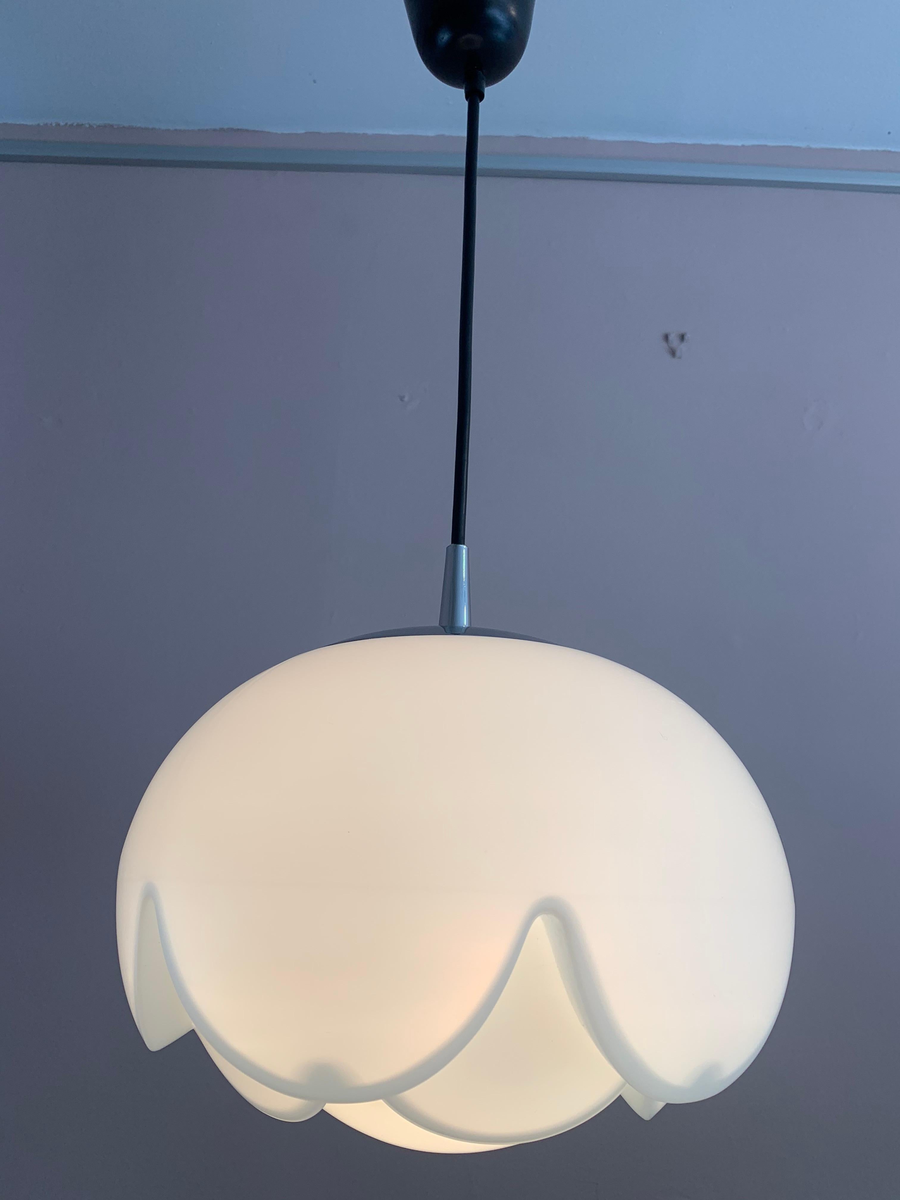 1970s German Peill & Putzler 'Artichoke' shaped opaline hanging pendant light. The shade is suspended from a chrome fitting which screws apart to allow access to the E27 screw in bulb. The light hangs from a black, height adjustable, flex with