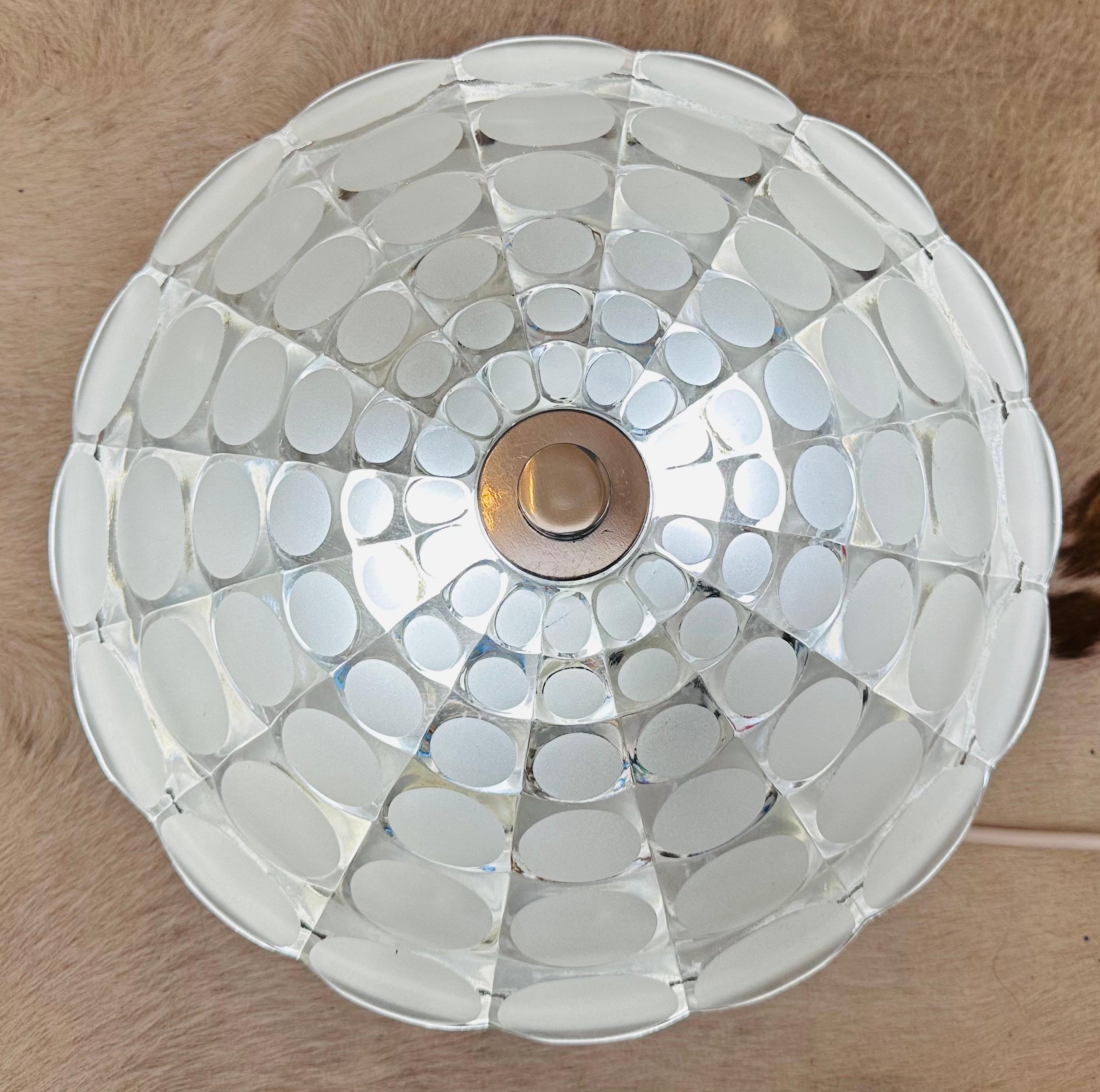 An unusual 1970s German Peill & Putzler flush mount ceiling light or large wall light. The circular glass shade is secured to the aluminium fitting with a bolt in the centre which sits inside the decorative chrome knob and disc. Two E27 screw in