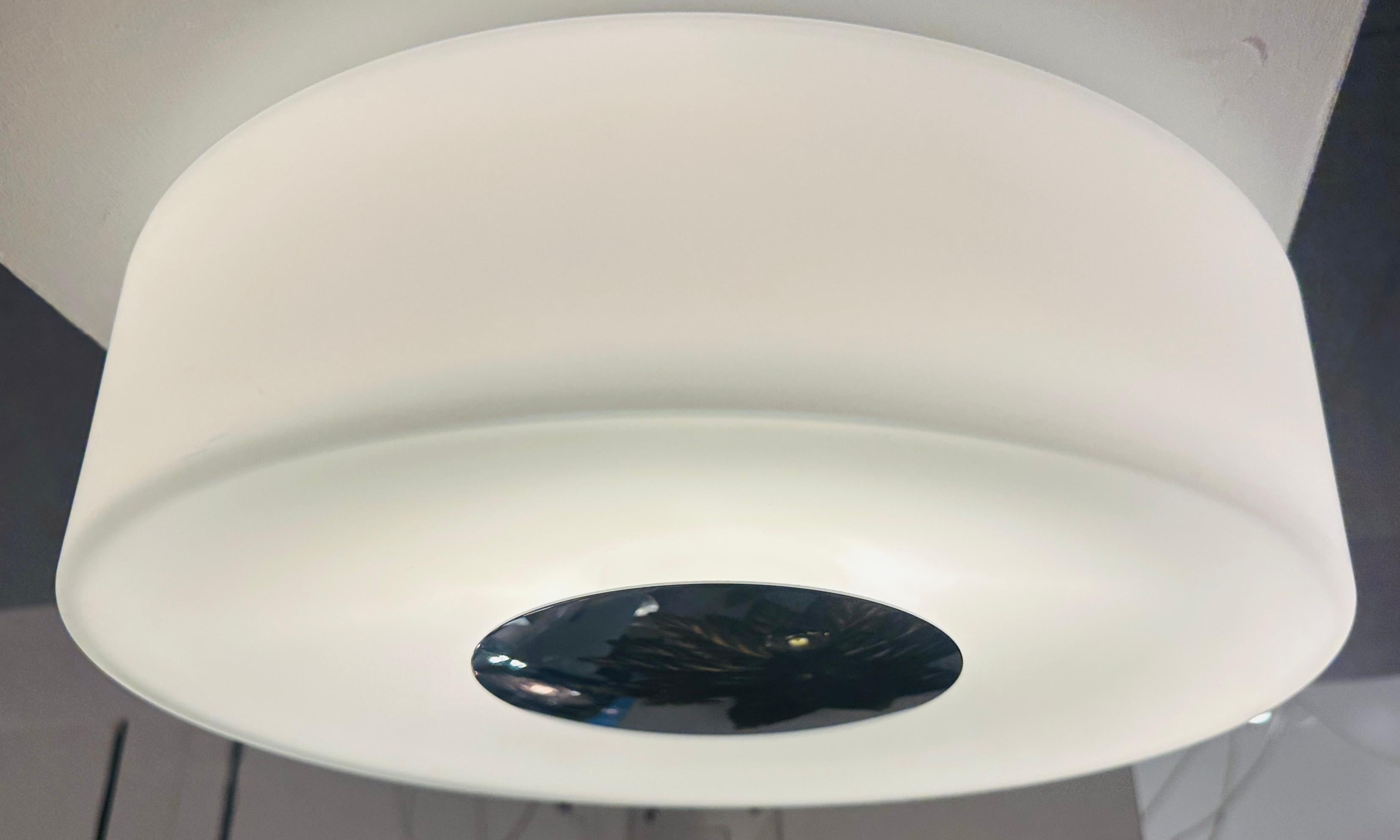 1970s Space age German Peill & Putzler opaline glass and polished chrome wall or flush mount ceiling light.  The opaline shade has three indents in the inner rim which slot on to the white metal ceiling plate.  It is then rotated to hold it in