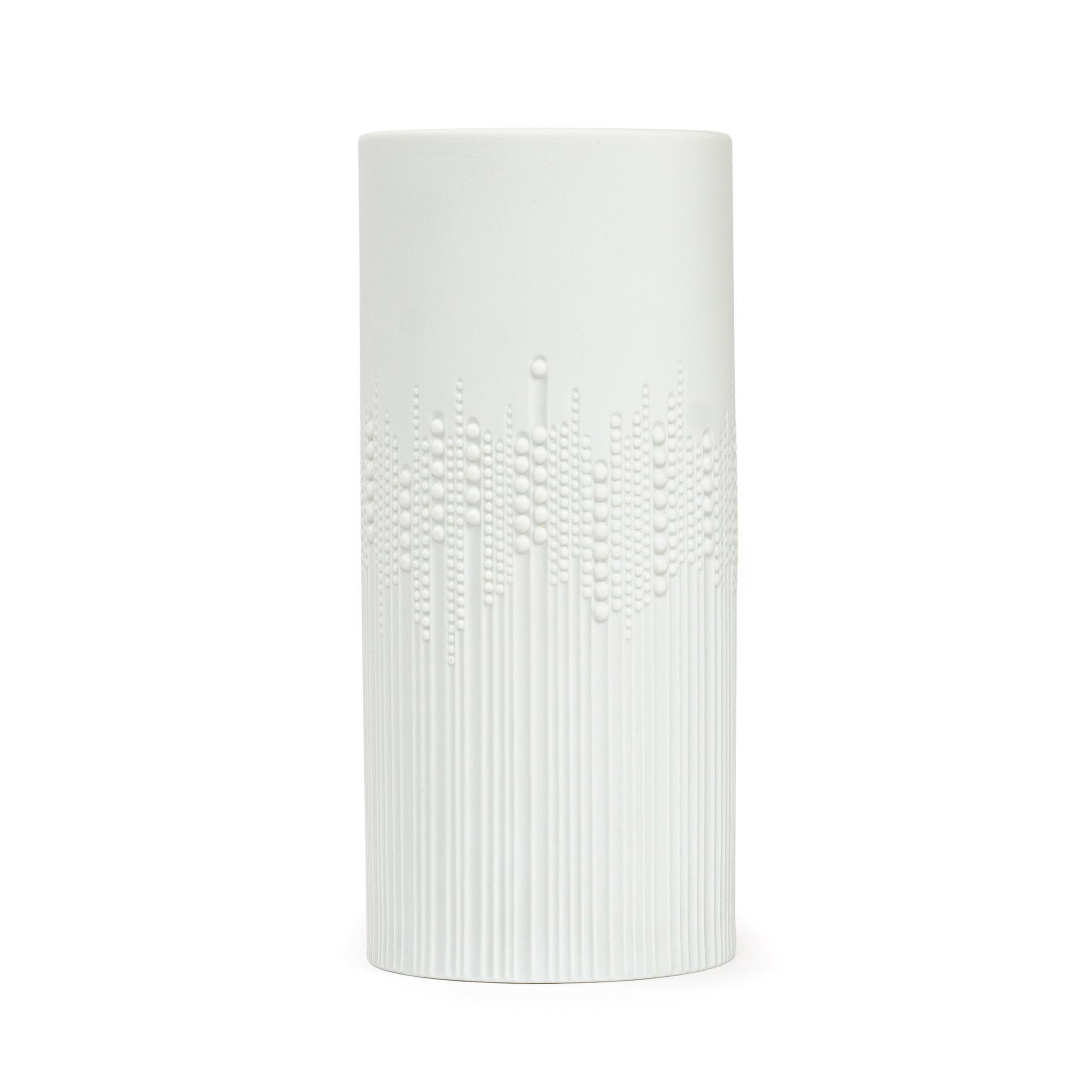 A tall, ovoid shaped white porcelain vase designed in 1970 by Tapio Wirkkala for Rosenthal Studio Line ‘Drops’ pattern as the tactile design on its exterior has raised dots, like rain droplets, against grooved channels. Matte finish exterior with a
