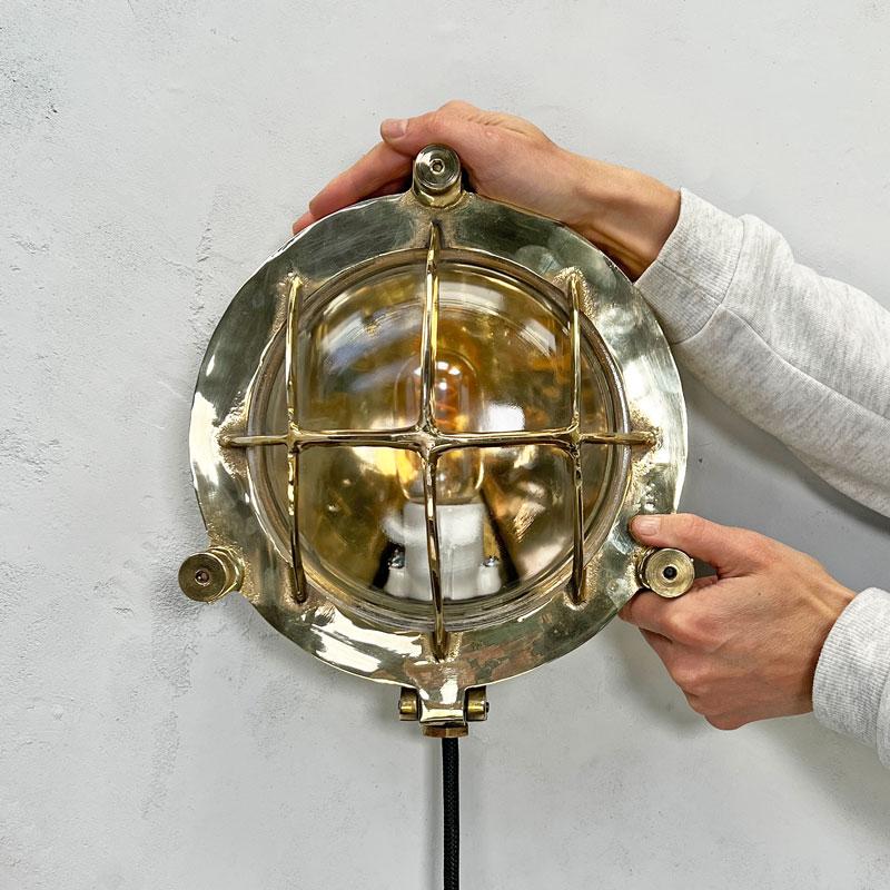 Vintage industrial circular brass bulkhead light by Wiska, a German manufacturer of industrial grade fixtures & fittings. These reclaimed nautical bulkhead lights manufactured c1970's have been professionally restored and rewired by hand in our