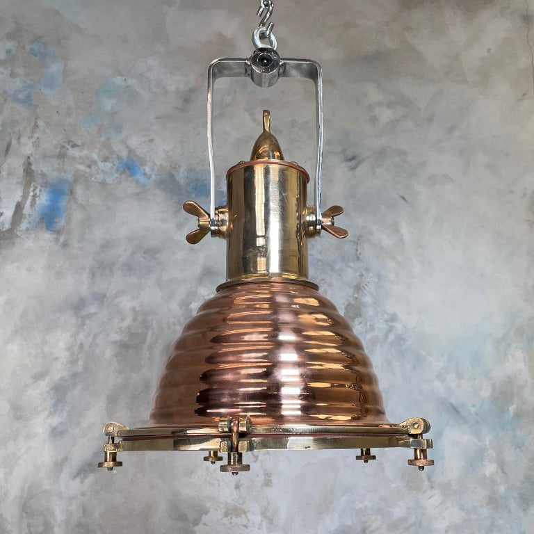 A reclaimed vintage industrial fluted copper and brass cargo ceiling pendant by Wiska. 
Great feature lights for vaulted ceilings or hang over a kitchen island for perfect rustic kitchen lighting. 
The dome section of the lamps are fluted spun