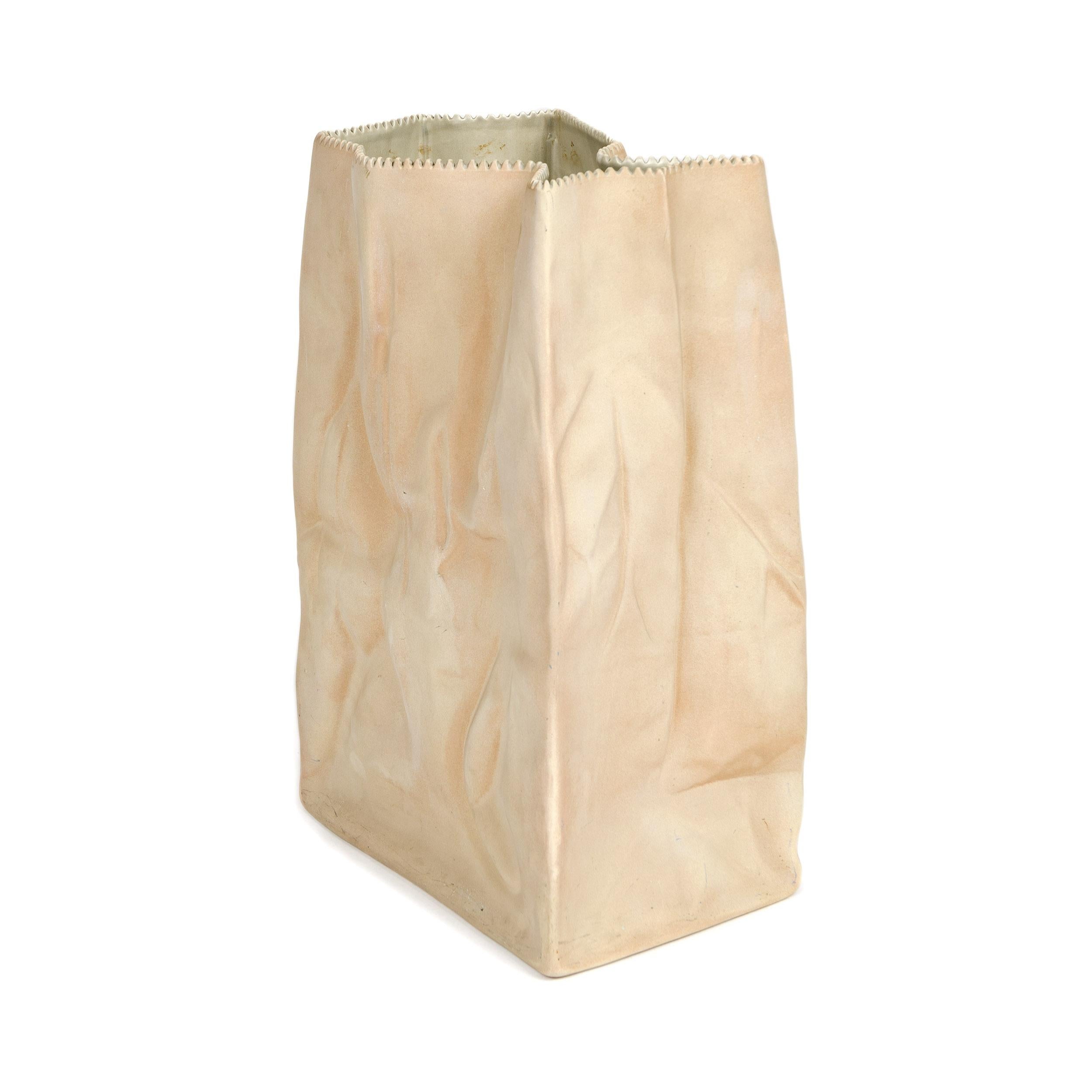 Paper or plastic or…Wirkkala’s fun and whimsical 1977 Pop Art take on tromp l’oeil, something that is not what it appears to be. Here, a used paper bag is actually a porcelain vase. Kraft paper brown with a serrated top edge, this bag vase is the