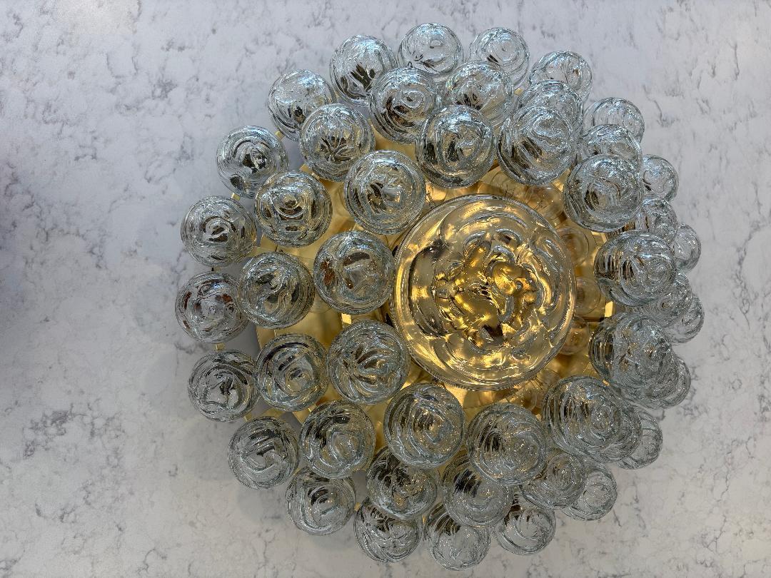 Spectacular 1970's Giant glass snowball flush mount ceiling fixture by Doria.
The polished brass frame supports three tiered rings holding a total of 48 glass snowballs each 3