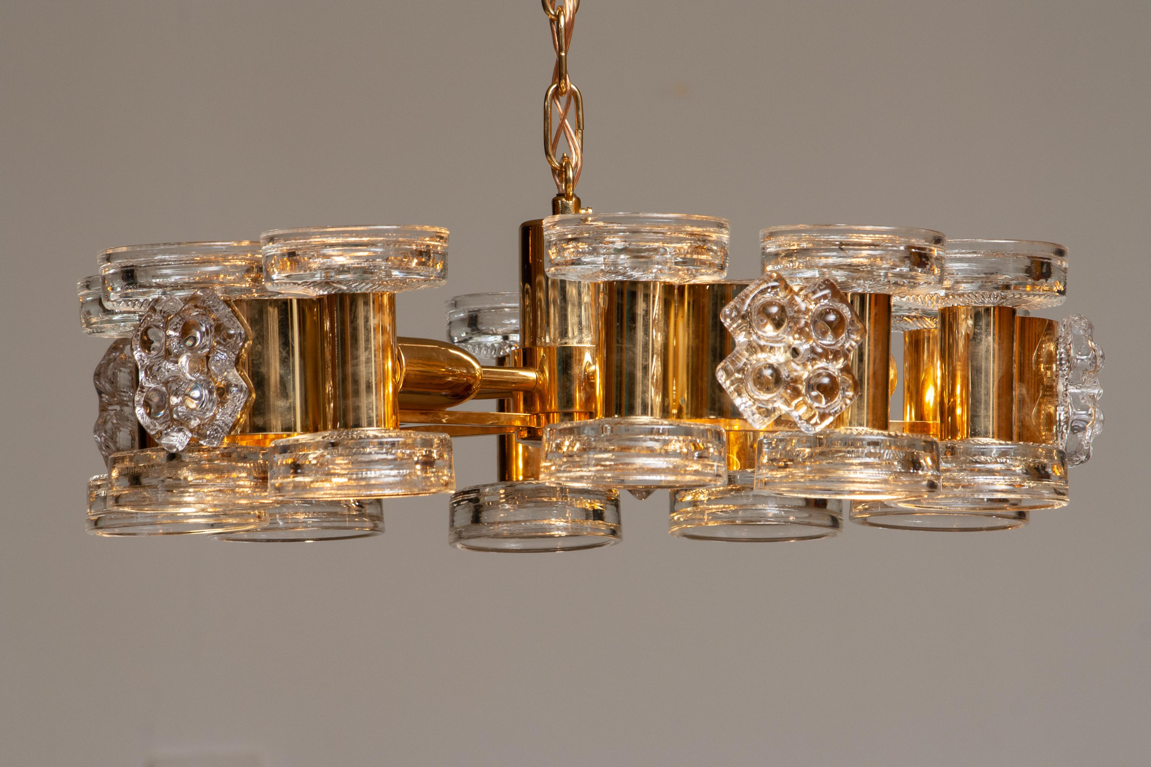 Beautiful gilded chandelier with ten candlesticks on top and five screw bulbs inside designed by Carl Fagerlund for Orrefors, Sweden, 1970s.
all-over condition is good. Technically 100%. The five screw bulb sizes are E14 /E17 and suits 230 / 110