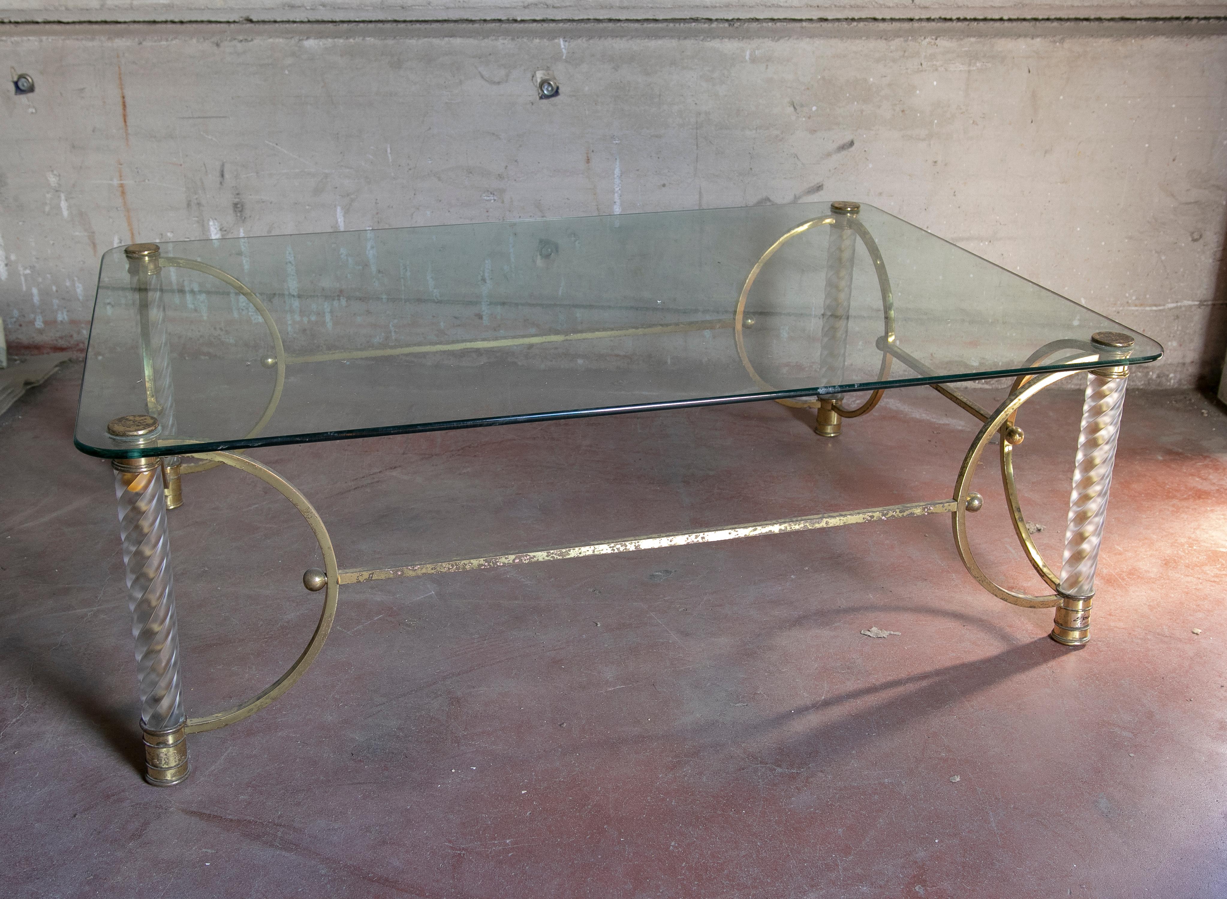 1970s gilded metal table with legs and glass table top.