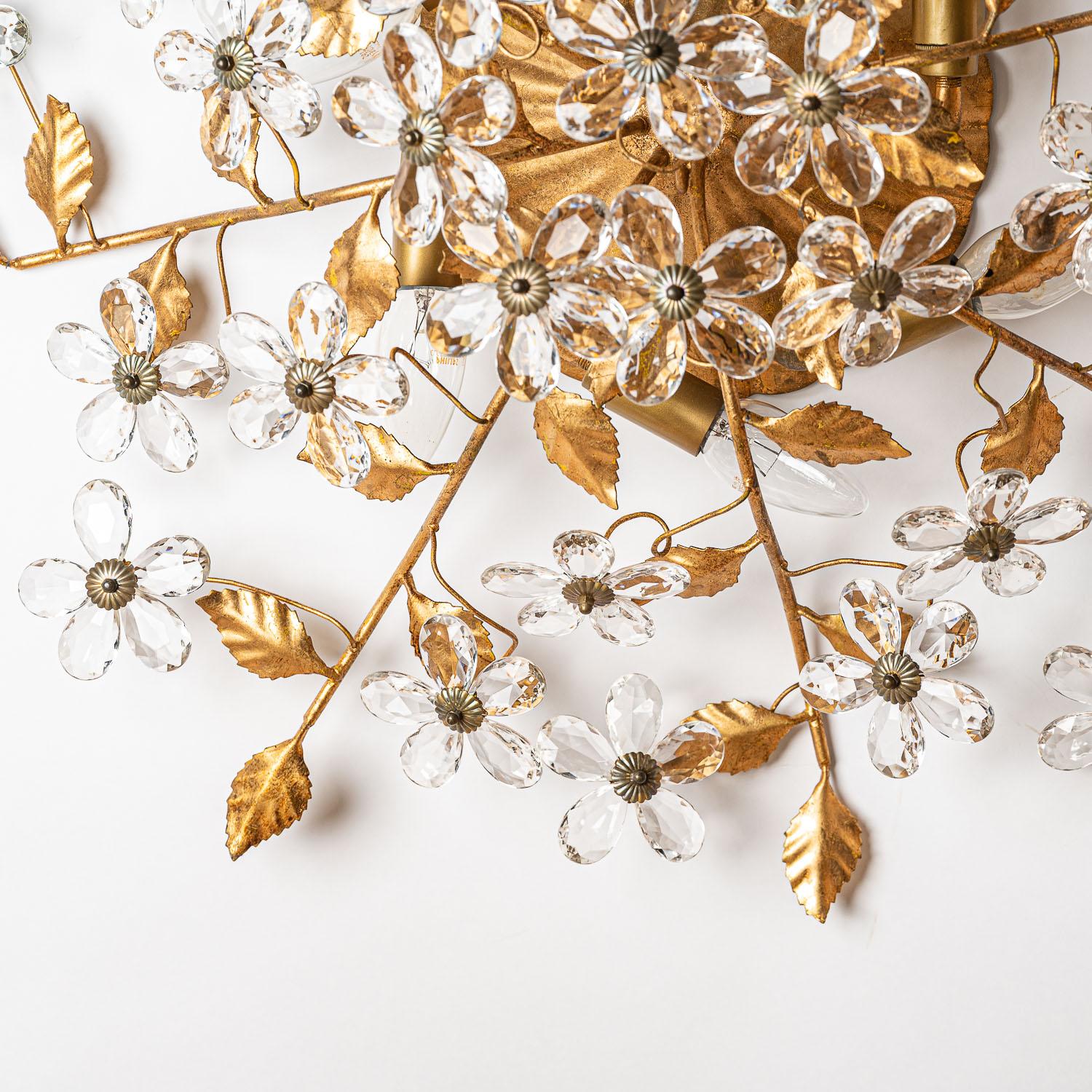Absolutely stunning flush mount that 'grows' along your ceiling. Gilt brass and crystal glass petals making beautiful flowers and stunning light.