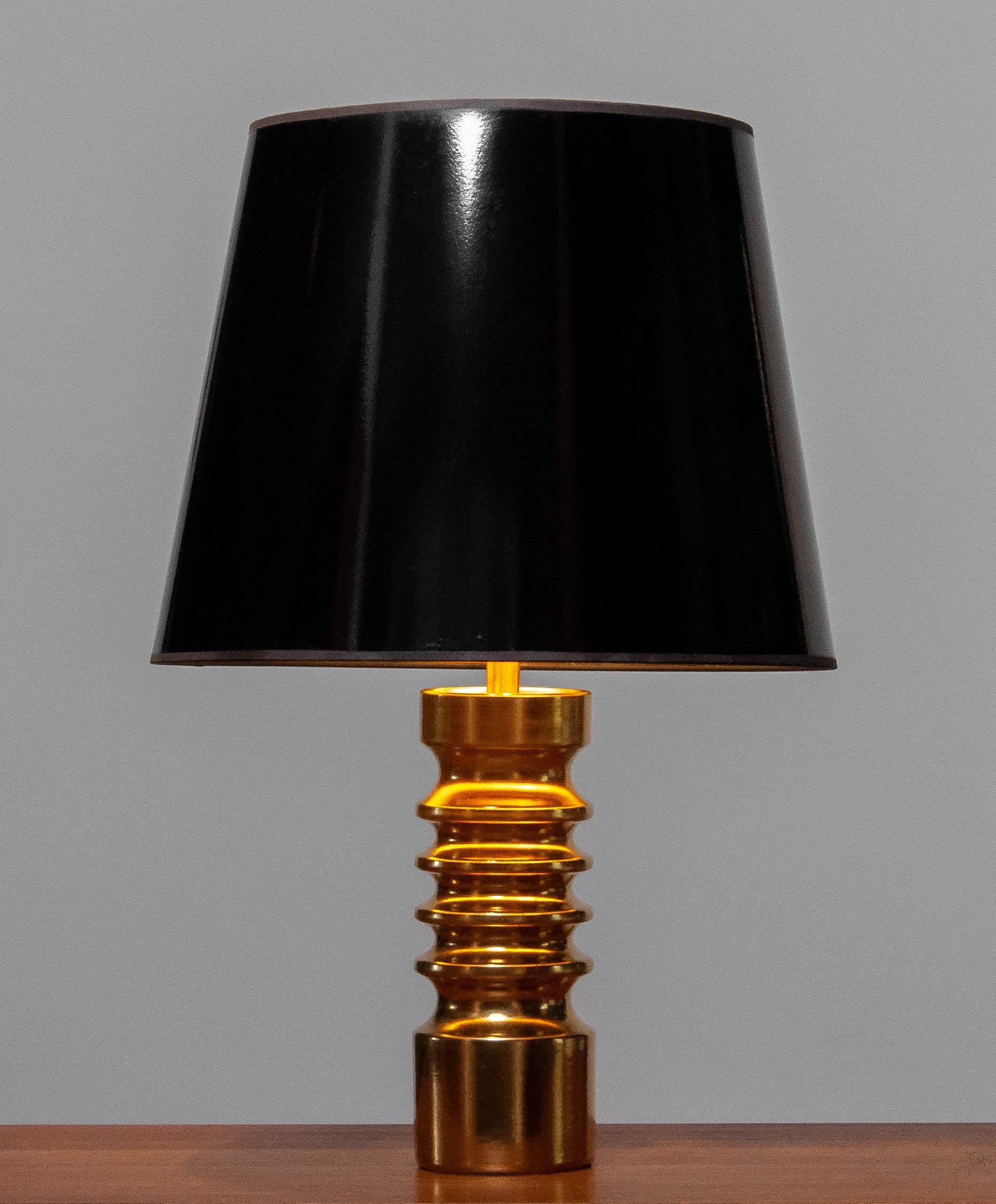 Äußerst seltene und schöne vergoldete zylindrische Keramik-Tischlampe von Dümler und Breiden in Deutschland aus den 1970er Jahren in durchweg sehr gutem Zustand. Die Tischleuchte ist mit einer Schraubfassung der Größe E28 und einem Kabelschalter