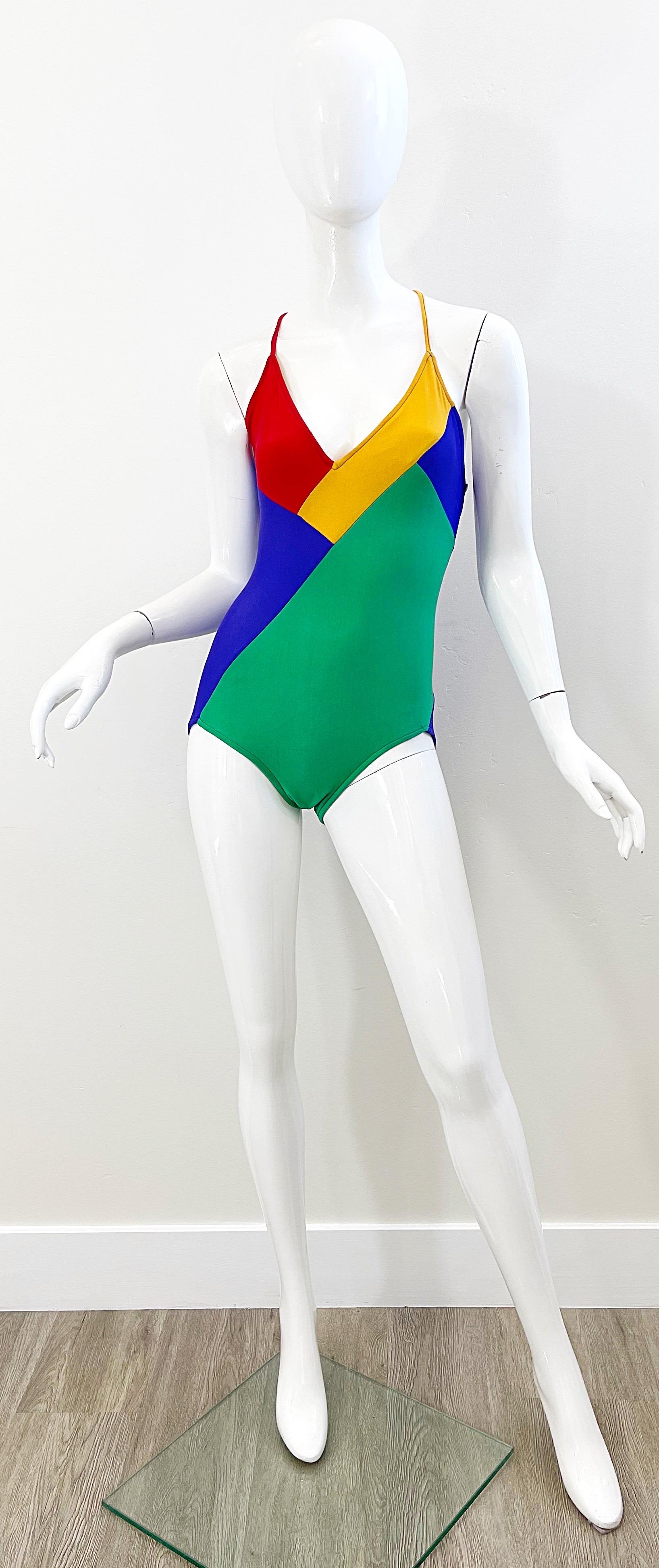 Sexy 70s GIORGIO di SANT ANGELO color block one piece halter swimsuit or bodysuit! Features vibrant colors of green, marigold yellow, red, and royal blue. Criss-cross ties in the back are adjustable. 
Great for the pool, beach, yacht, or tucked in