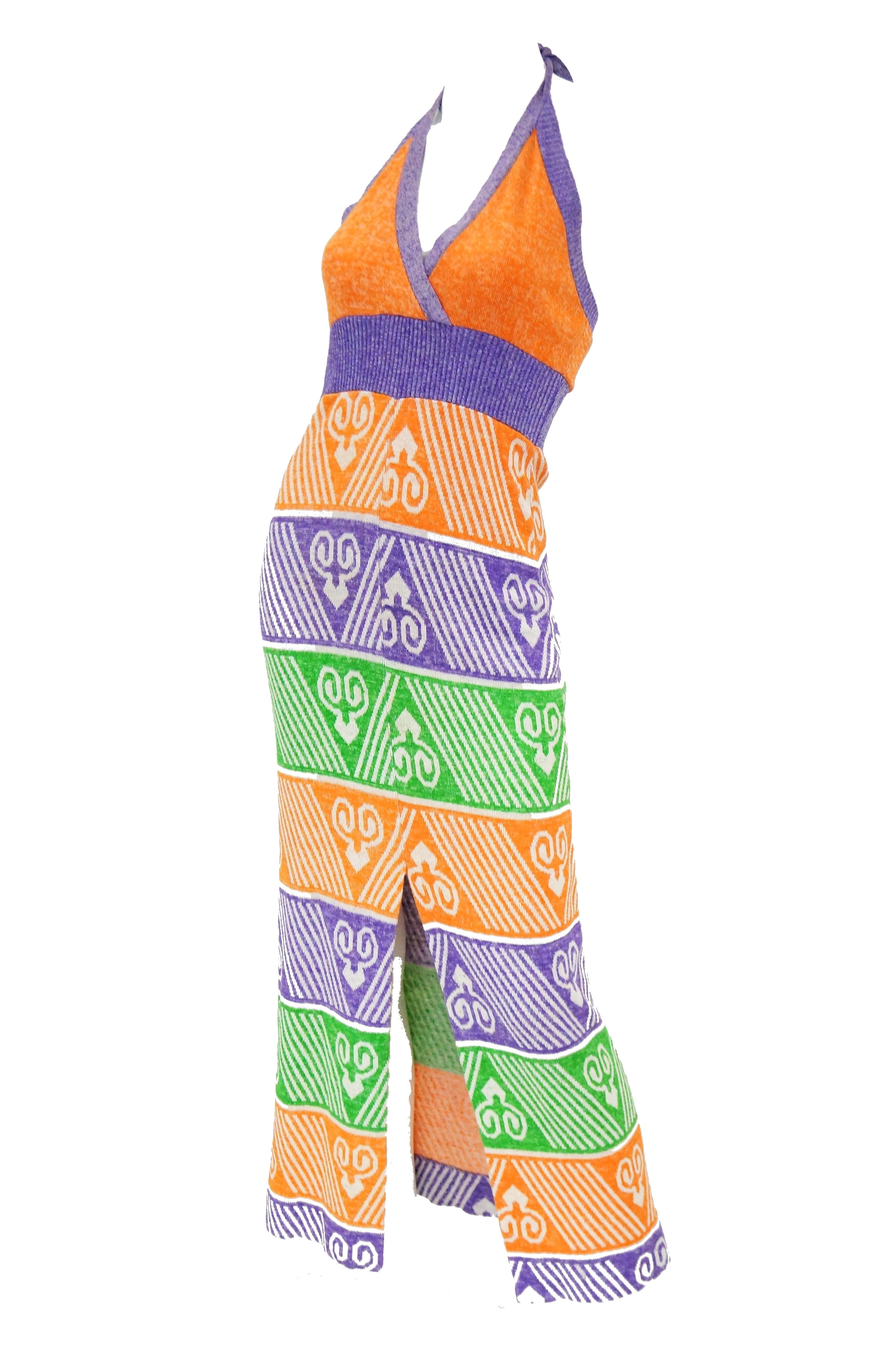 Bright and playful day dress by Giorgio di Sant Angelo, master of knitwear! The maxi length, knit, sleeveless dress features a body conforming silhouette, and a halter top closure at the back of the neck. The dress has a wrap bodice that is