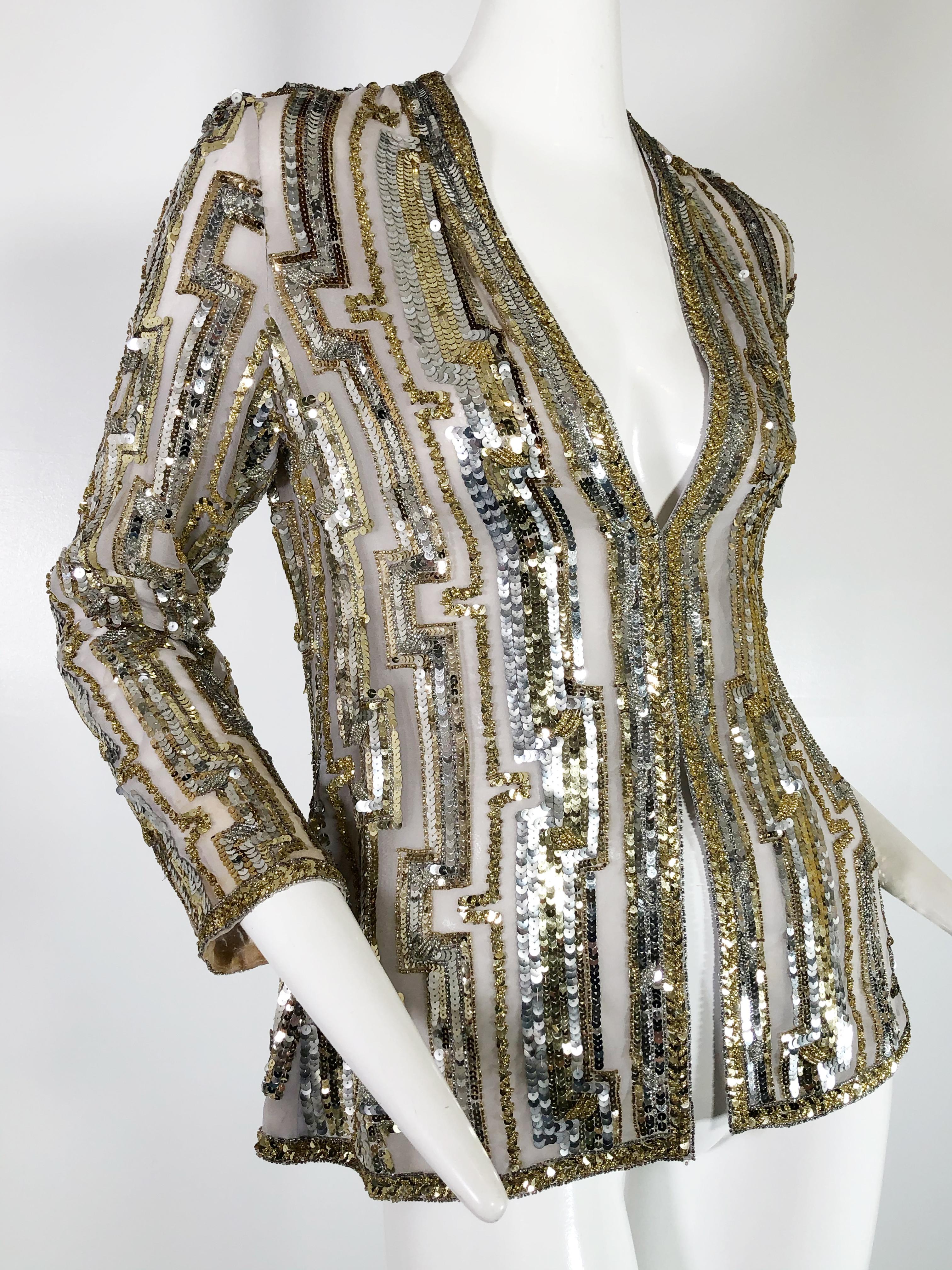 A gorgeous 1970s Giorgio of Beverly Hills silk organza evening jacket encrusted with silver and gold sequins in a geometric stripe pattern. Hidden hook and eye closures
