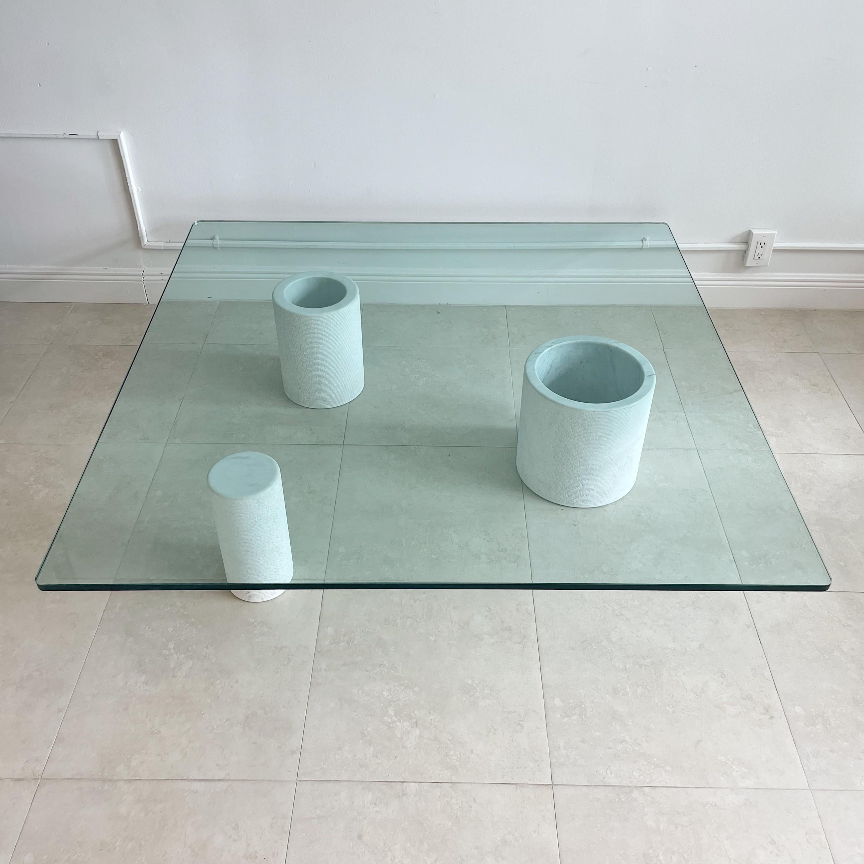 Glass top coffee table with 3 graduated white marble cylindrical pedestals by Giulio Lazzotti for Casigliani, titled 