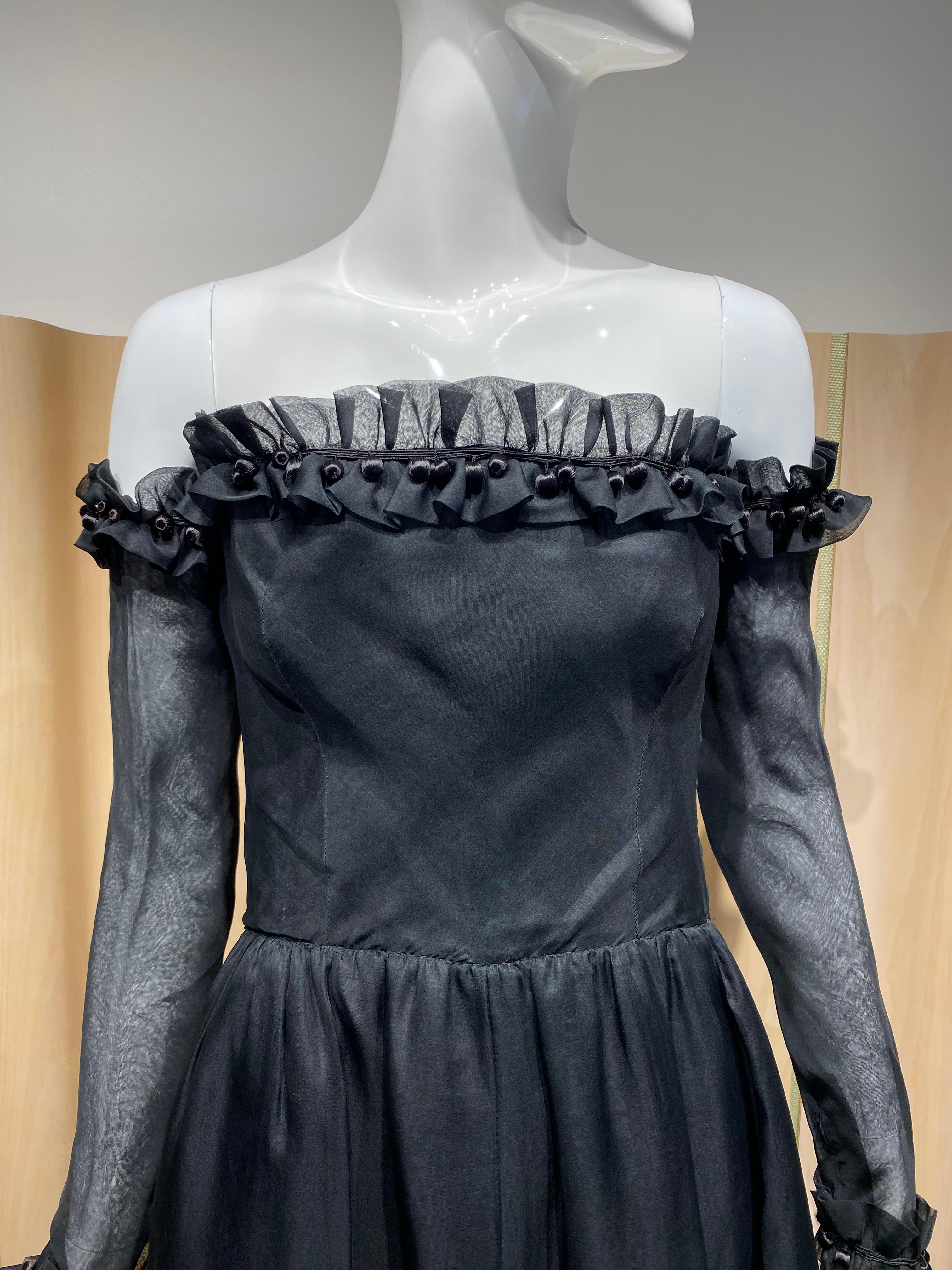 1970s Givenchy by Hubert de givenchy strapless black silk organza dress with ruffle and detachable sleeves. ( see (1970s advertising )
Fit size 0/2 
measurement:
Bust 32” / Waist 24” / Dress length 55”
sleeve length: 23” / sleeve top diameter 8
