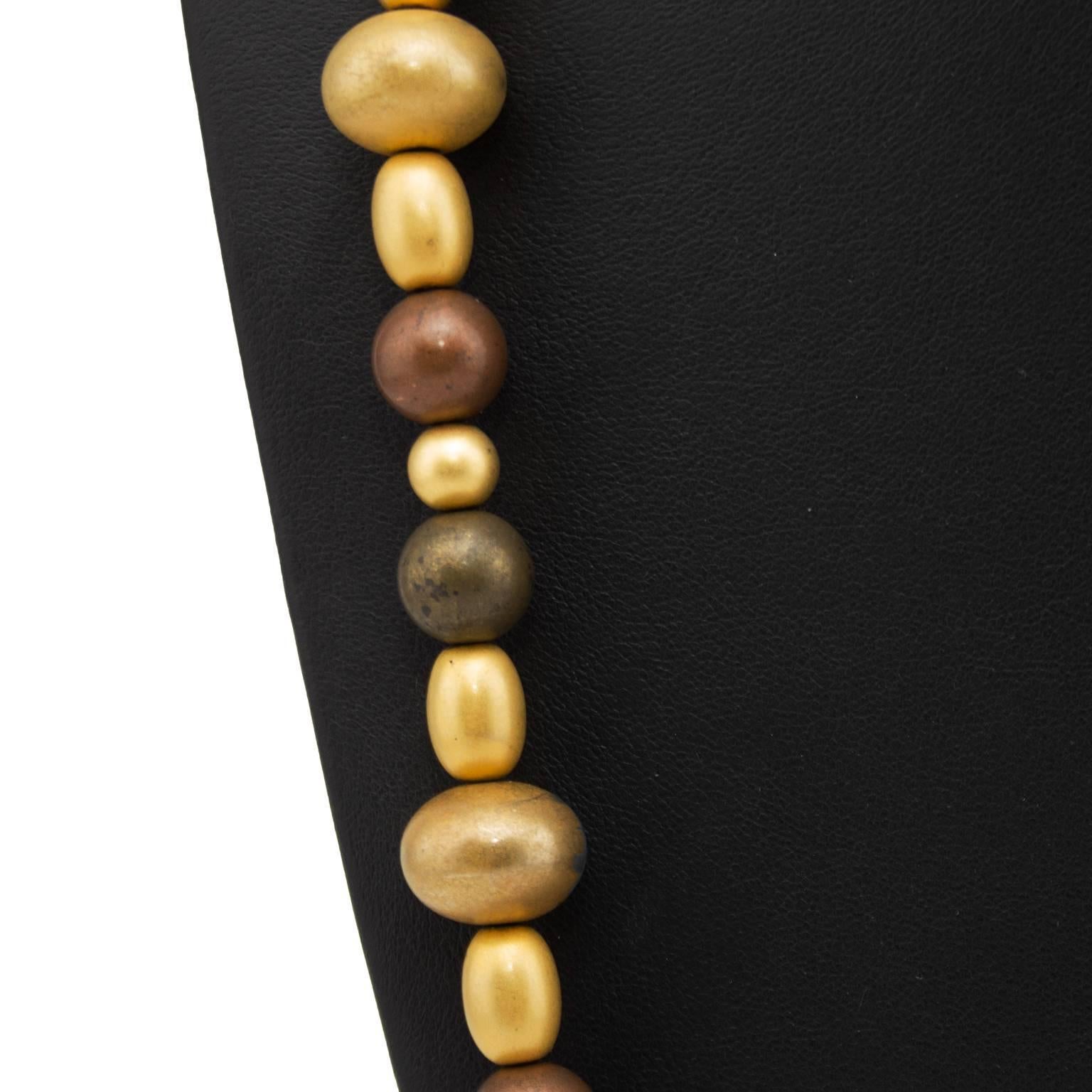Oval and round bronze, brown and gold beads make up this Givenchy necklace from the 1970s. With an overall length of 37