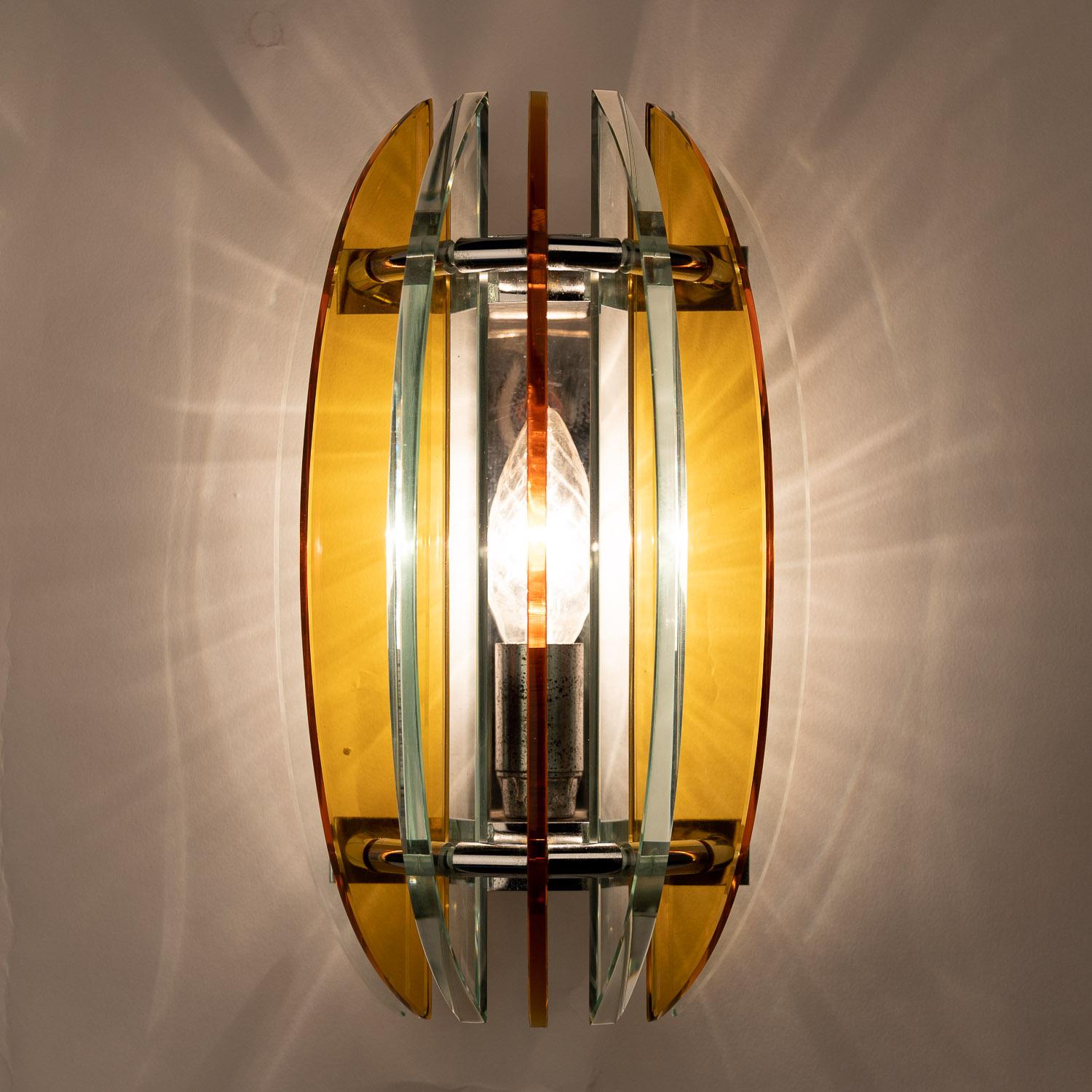 This is a stand-out piece from the designer Veca in Italy. At the cutting-edge of 1970s design, this set of lighting is bold and beautiful. Bladed glass wedges orange in colour, surrounding a single E14 bulb. Authenticity is guaranteed with the