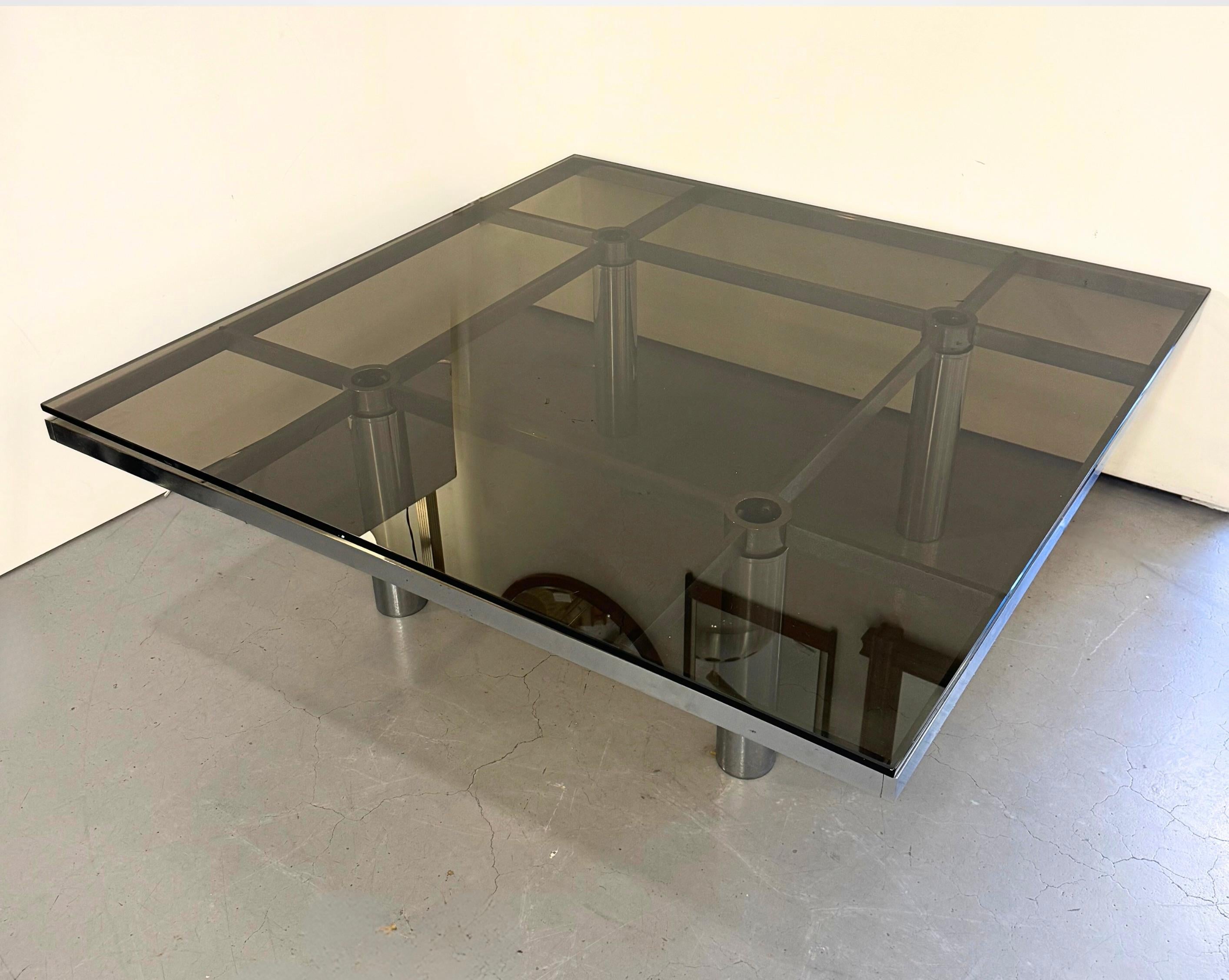 Mid-Century steel and smoked glass coffee table by Tobia Scarpa for Gavina.
Part of the 'Andre' range, circa 1970s.
Low lying coffee table of tubular polished steel, with a geometrical checkered steel platform, supporting 5mm thick smoked glass