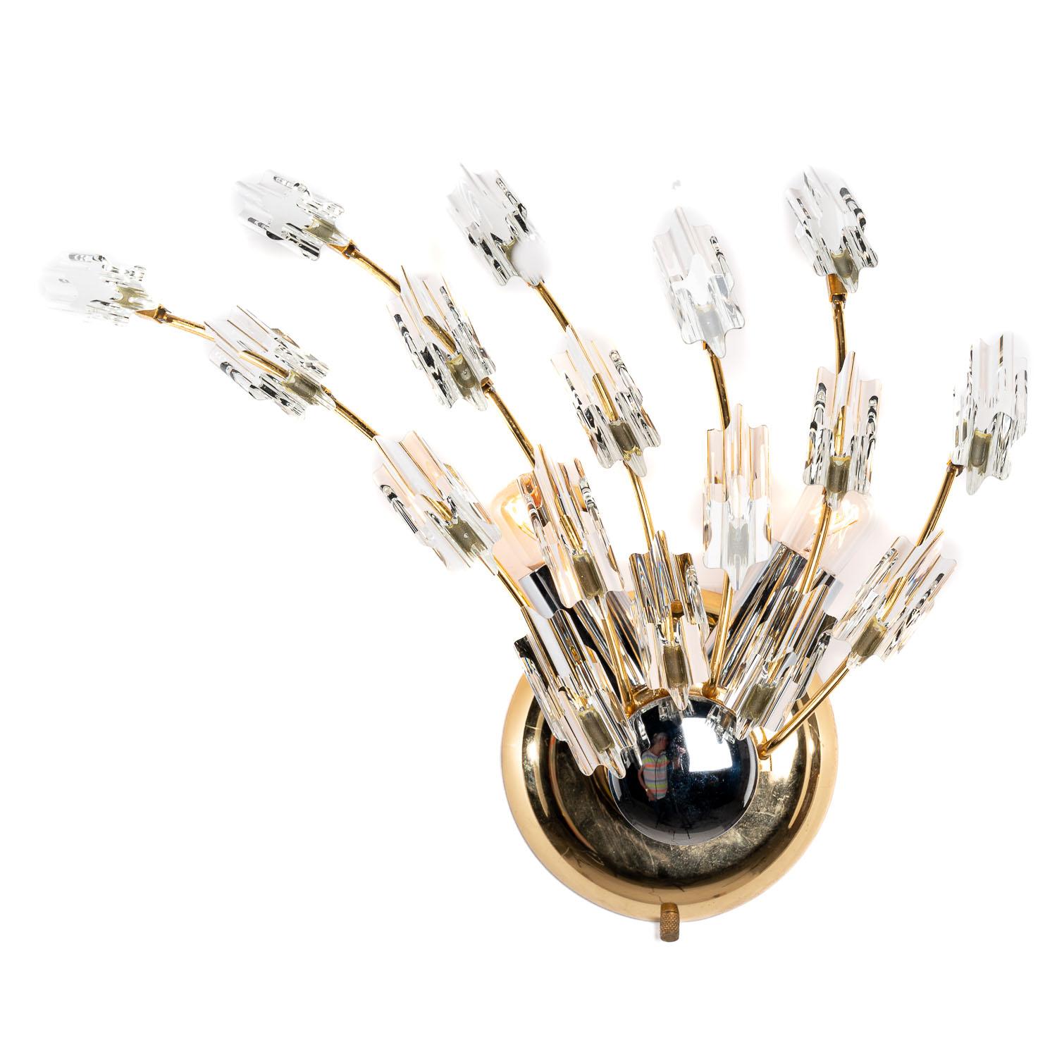 If you're looking to blend design and functionality into one item, this piece does just that and then some. Coming in two parts, chrome and brass base units each support several curved stems adorned with sculpted shards of glass. One piece does have