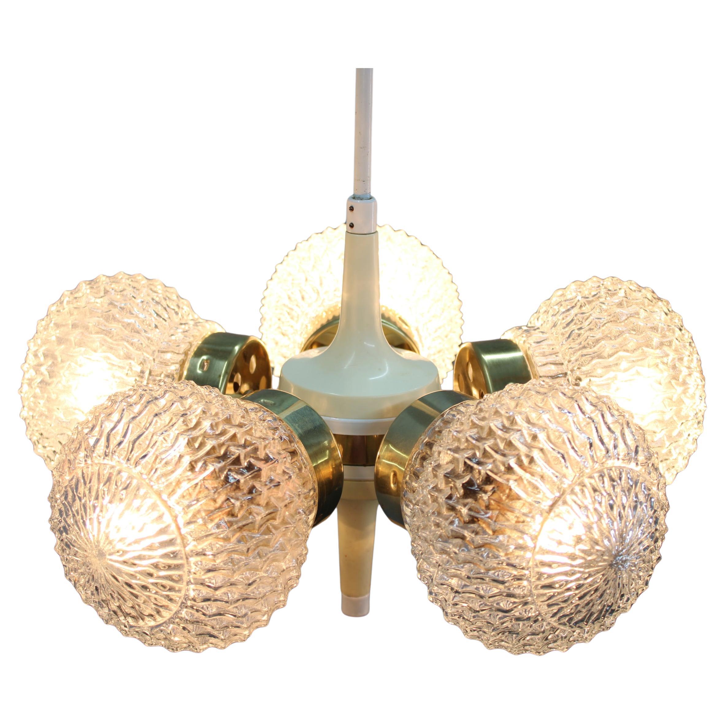 Chandelier by Instala Decin, in the 1970's, in Czechoslovakia.
Made of metal, brass and glass.
Repolished, cleaned, shows minor signs of use, includes newly installed cabels.
Fully functional.
