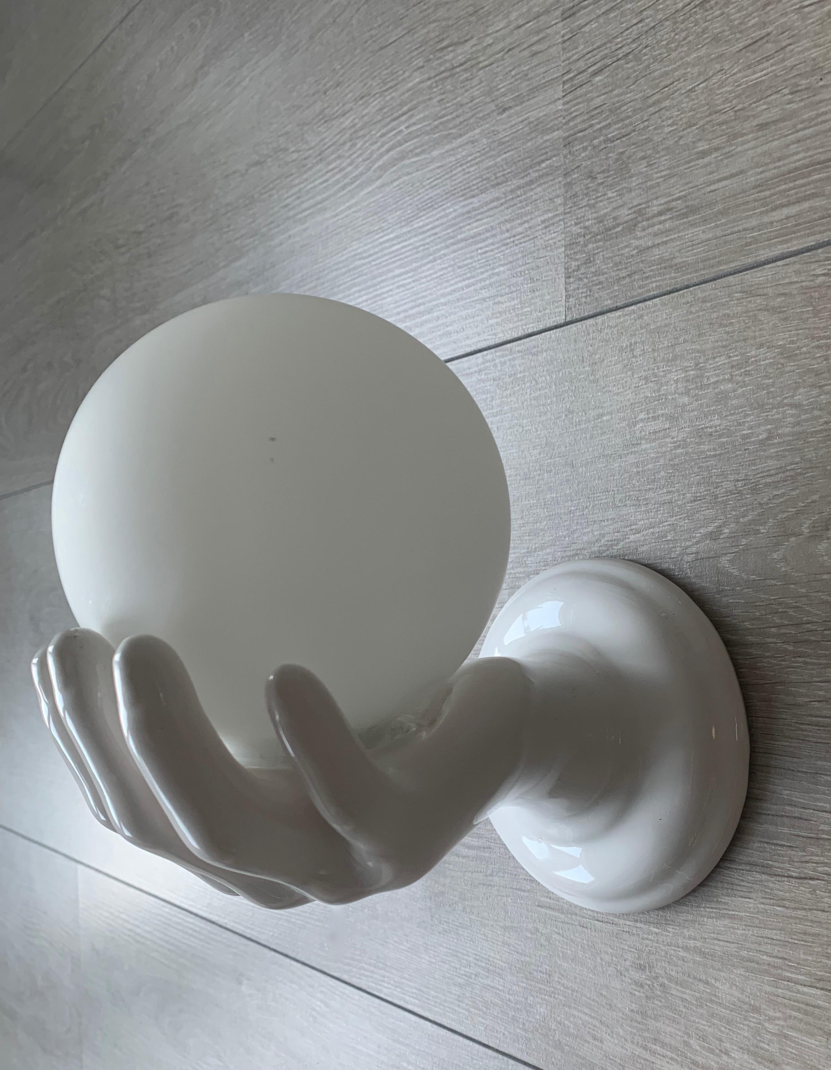 Modern 1970s Glazed White Ceramic Hand Holding a Glass Globe Wall Sconce or Wall Light