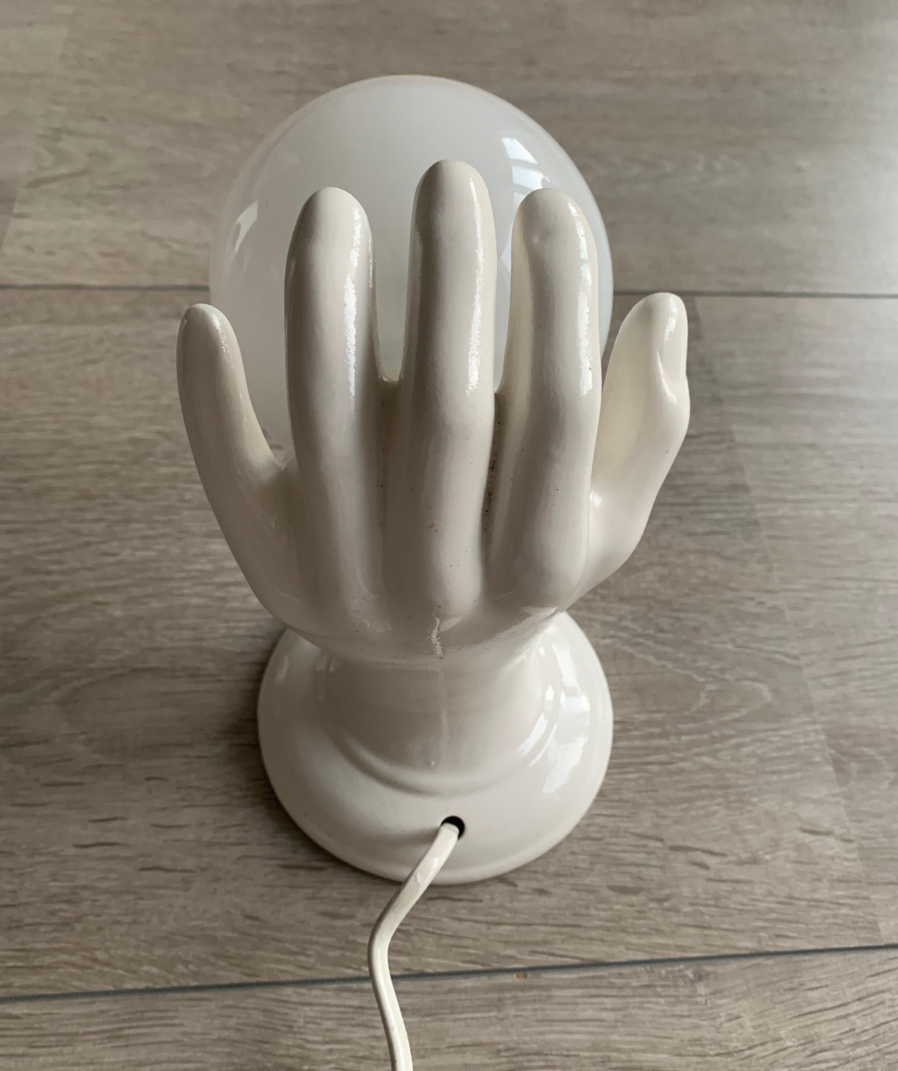 Modern 1970s Glazed White Ceramic Hand Holding a Glass Globe Wall Sconce or Wall Light