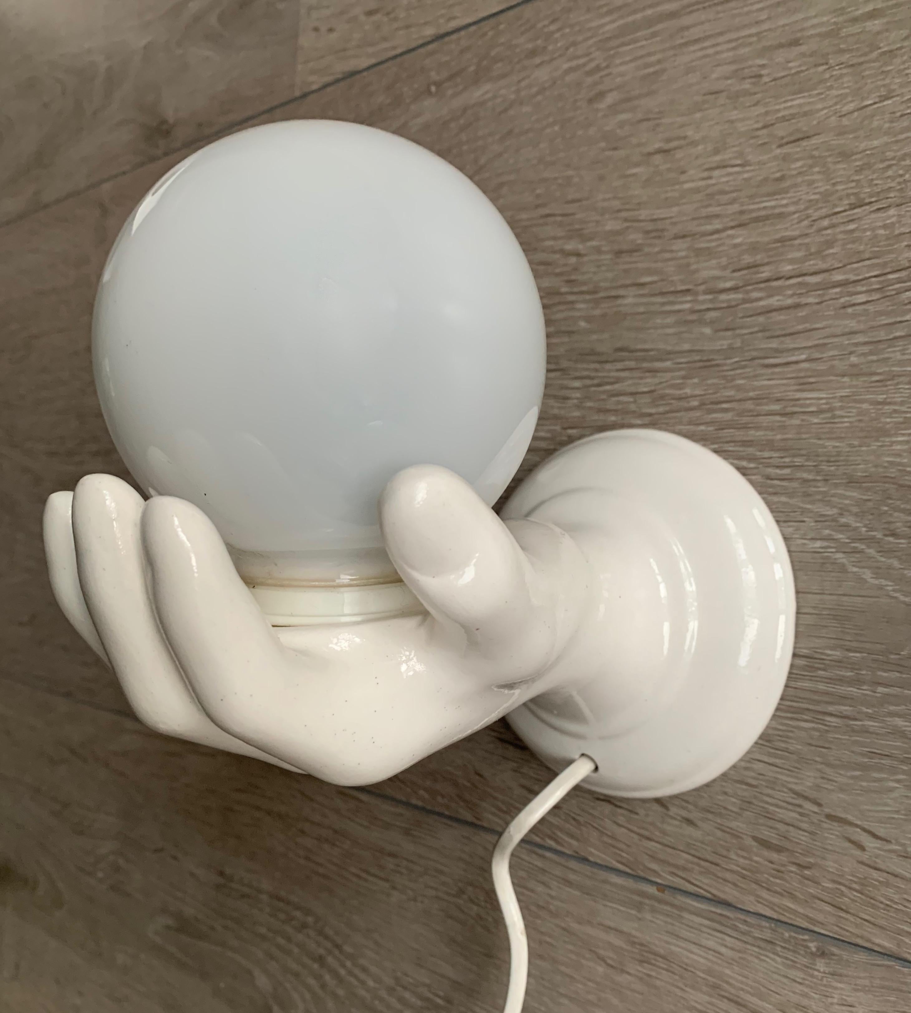 20th Century 1970s Glazed White Ceramic Hand Holding a Glass Globe Wall Sconce or Wall Light