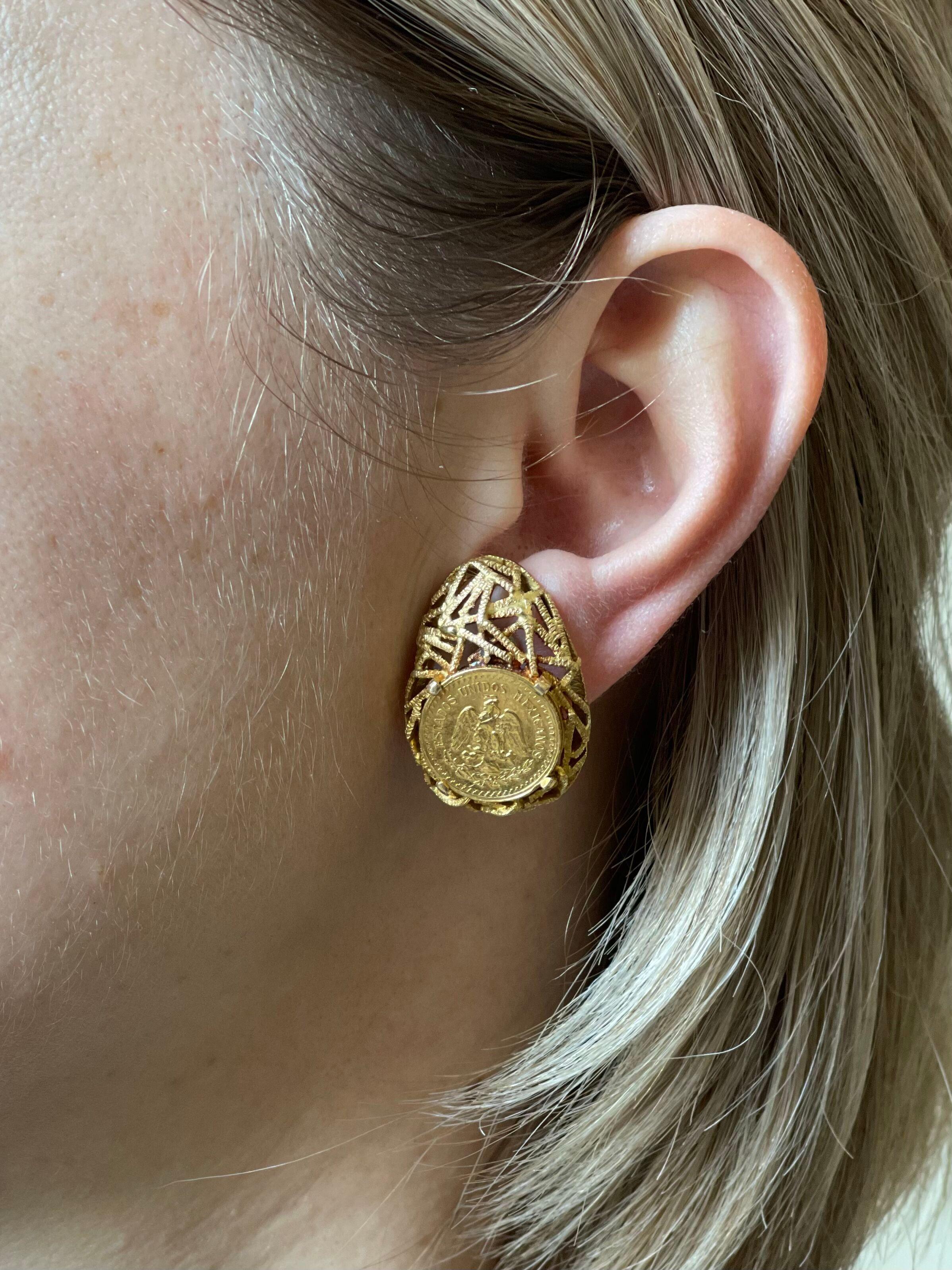 Pair of vintage 1970s 18k gold earrings, featuring center gold coins and sticks designer. Measure 1 1/8