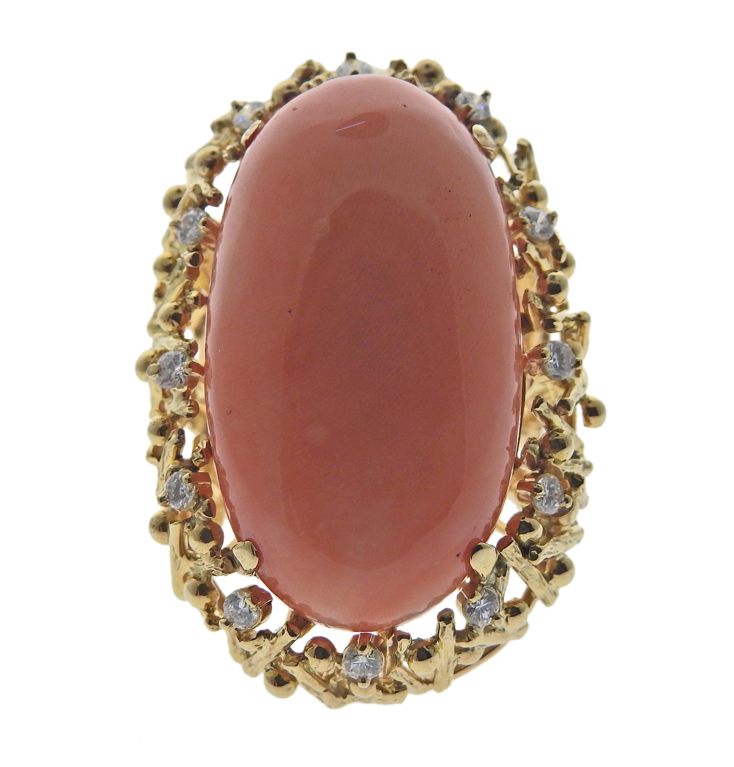 1970s gold diamond coral cocktail ring features approx 0.60ctw in VS1/SI1 H diamonds. Ring size 5 3/4, top of the ring measures 38mmx x25mm. Coral is 31.5mm x 18mm. Marked: 18k. Weight is 26.9 grams.