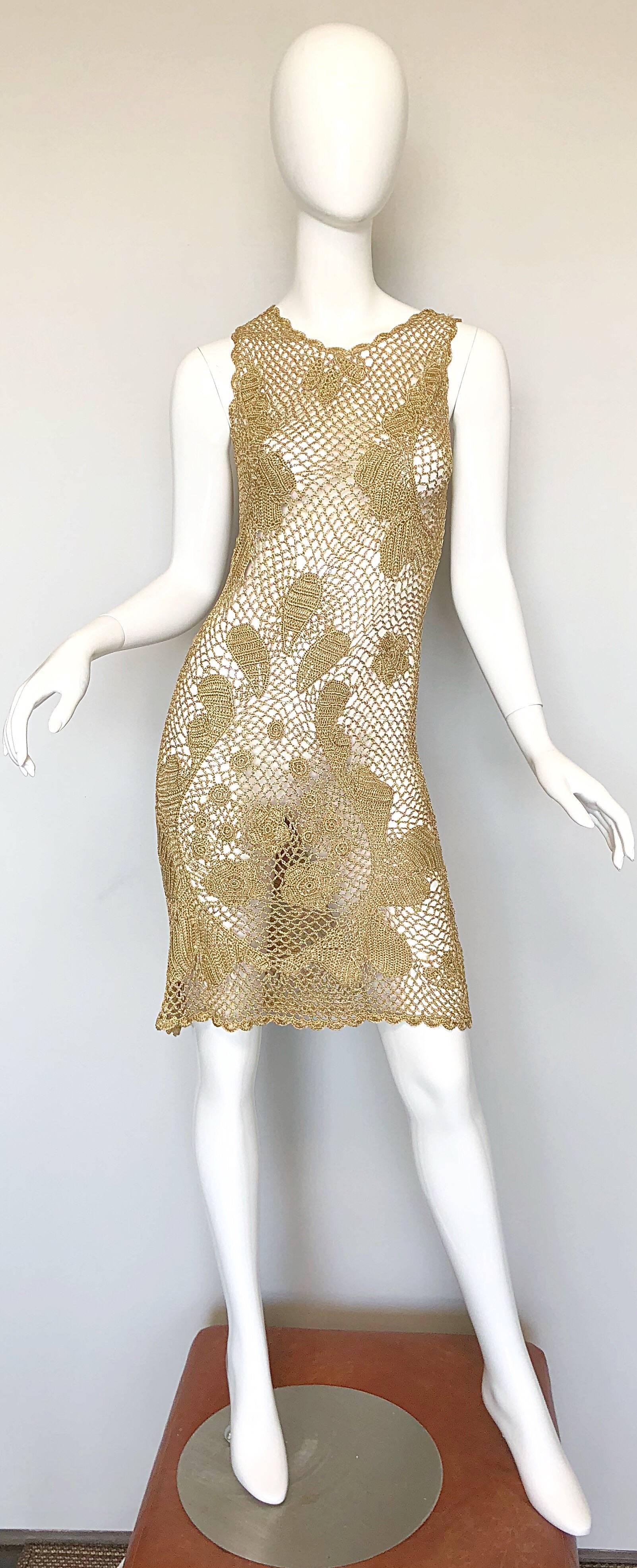 Sexy 1970s gold metallic hand crochet rayon dress! Features a soft gold metallic rayon, with designs cleverly placed over each breast, and at the crotch. Button at top back center. Great alone, over a swimsuit, with jeans, etc. In great unworn