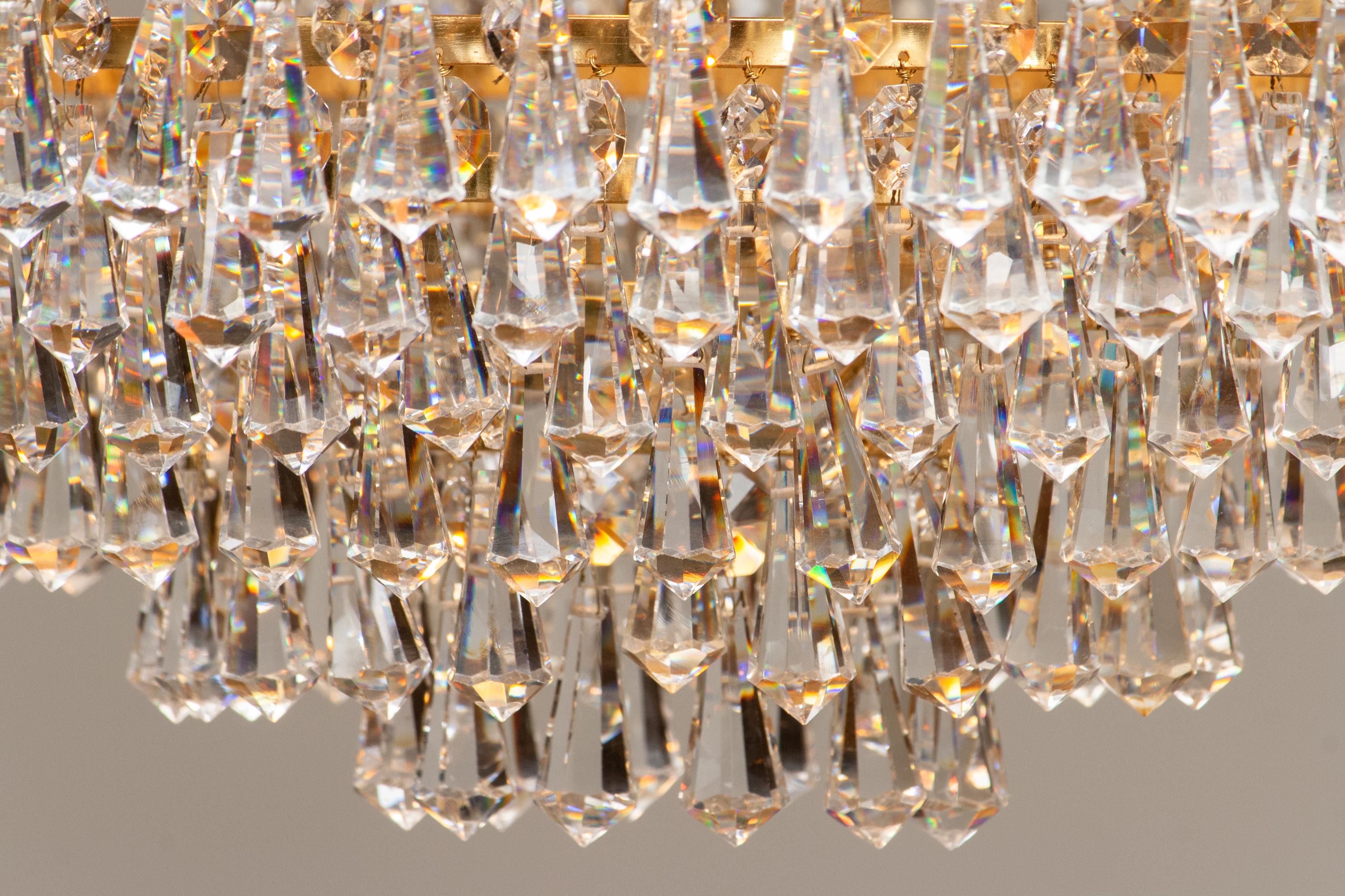 Beautiful gold-plated chandelier attributed to Rejmyre Armaturfabrik Rejmyre, Sweden, 1970s.
The chandelier is build up out of six rings and two crowns filled with faceted crystal, total diameter of the fixture is 44cm or 17