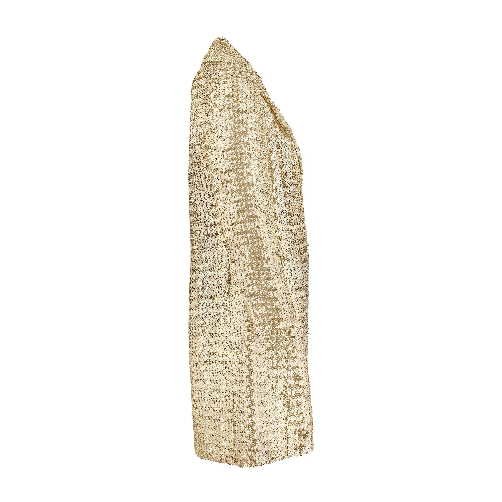 Made in Studio City, California, during the 1970s, this striking A-line coat is perfect for making an entrance at a glitzy event. Heavily smothered in high-shine gold sequins, it has long shimmering sleeves and a three-quarter length hemline.