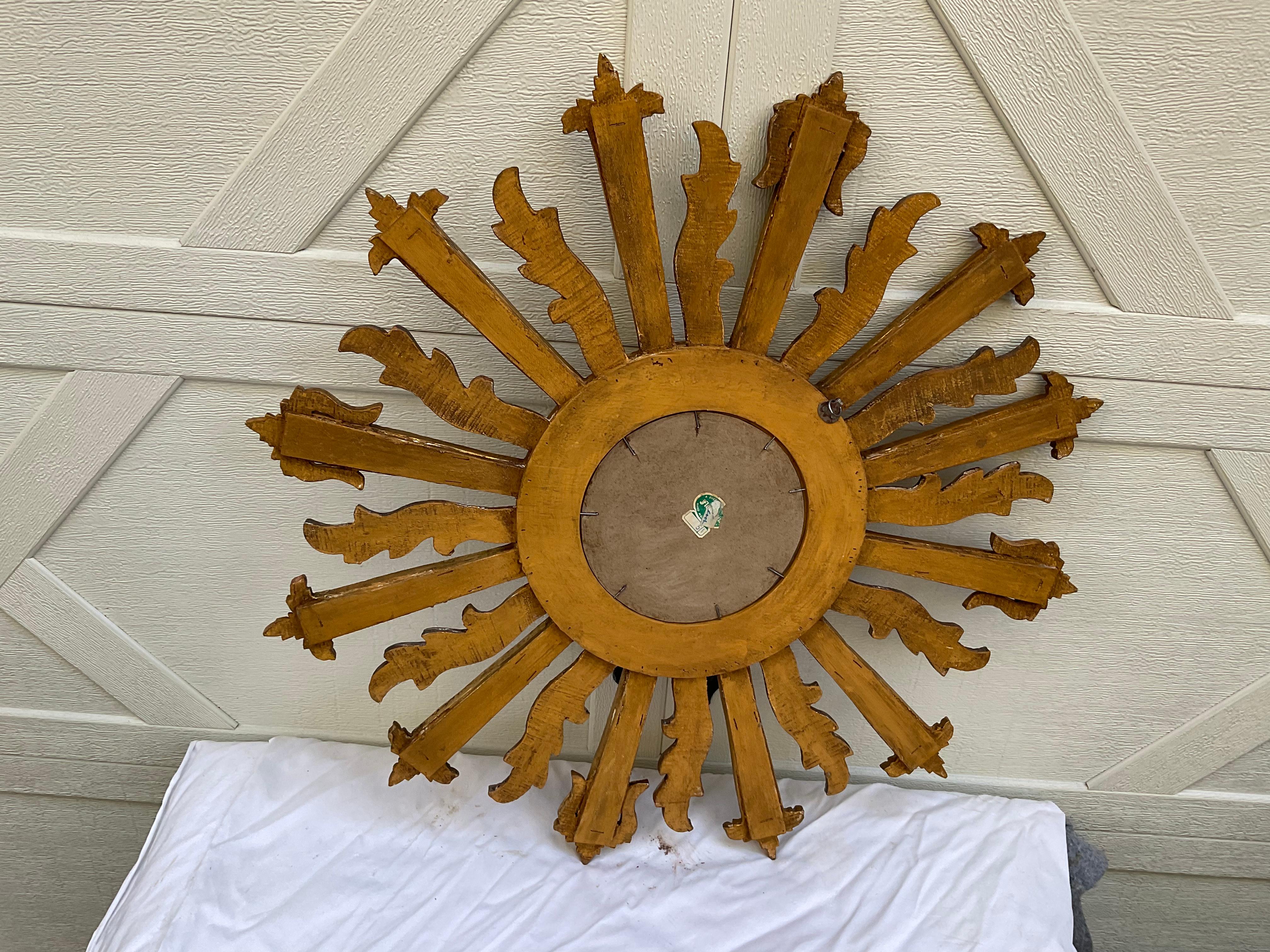 Unusual gilt wood sunburst mirror from the 1970s. Mirror has both silver and gold rays. Center mirror measures 7” D. No repairs or breaks to the wood. There are a couple of small breaks in the mirror, on 2 rays. Not noticeable. A nice mirror to add